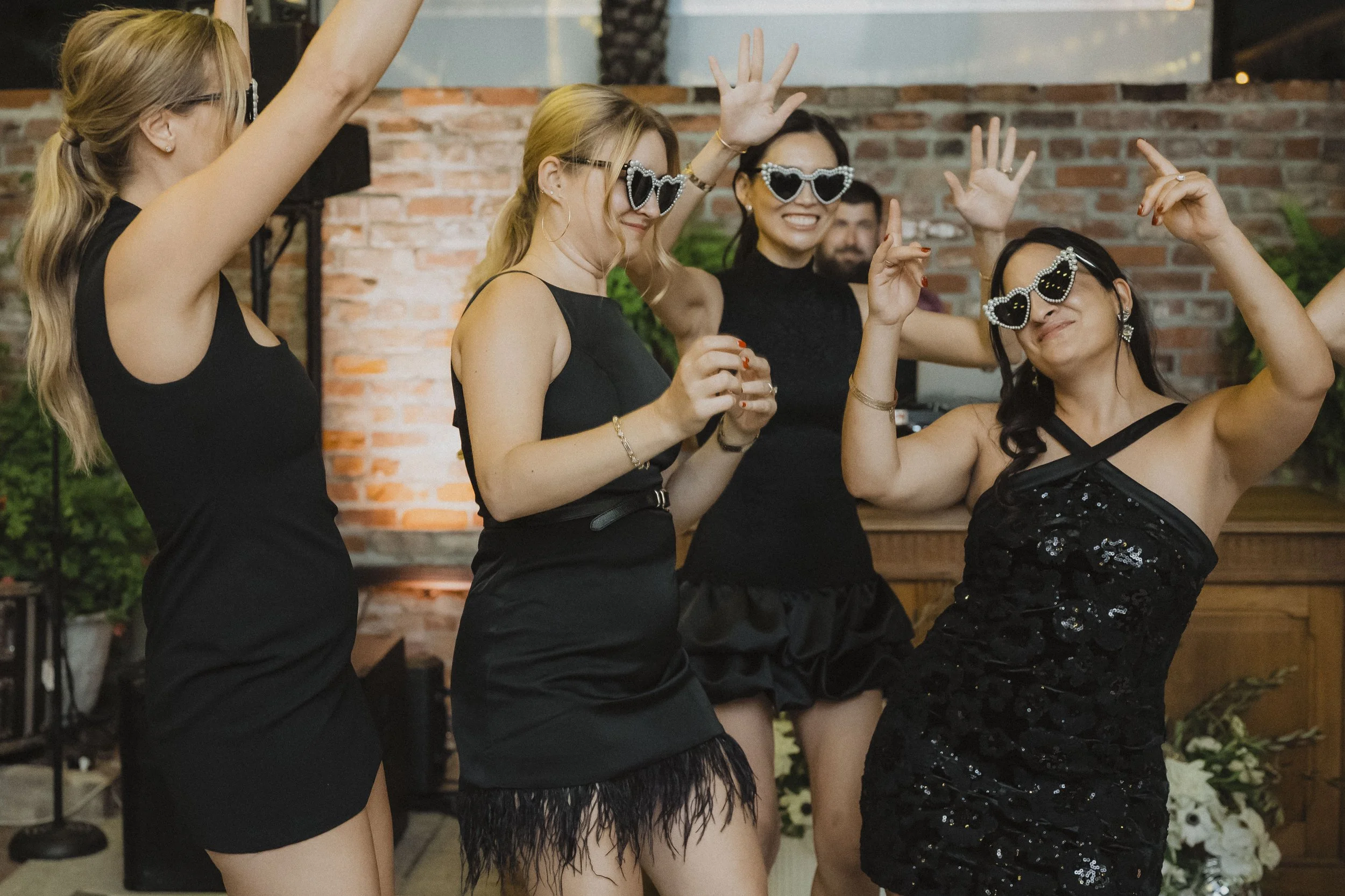Friends celebrating together on a packed wedding dance floor