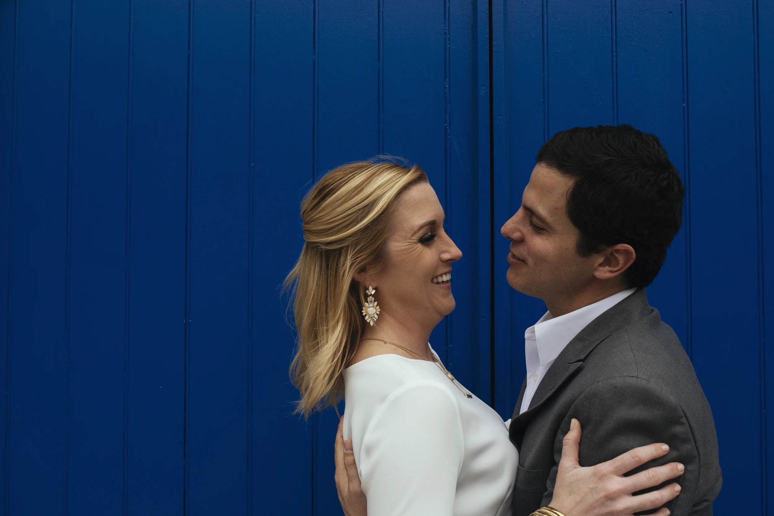 couple against blue wall