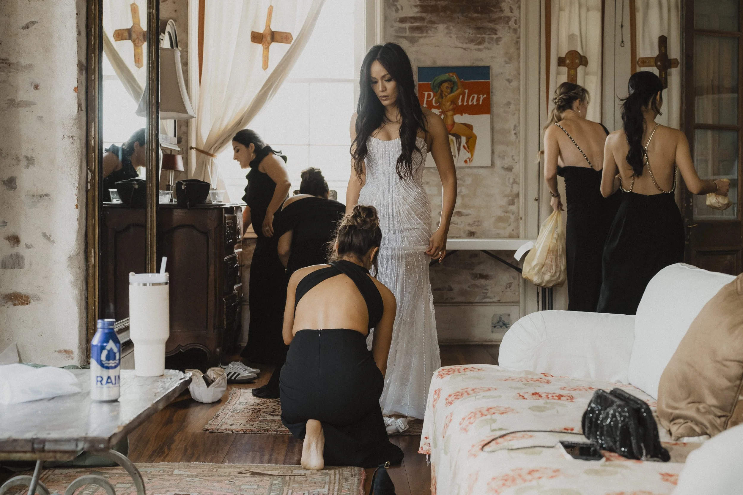 Bride gets ready with friends before her wedding ceremony.