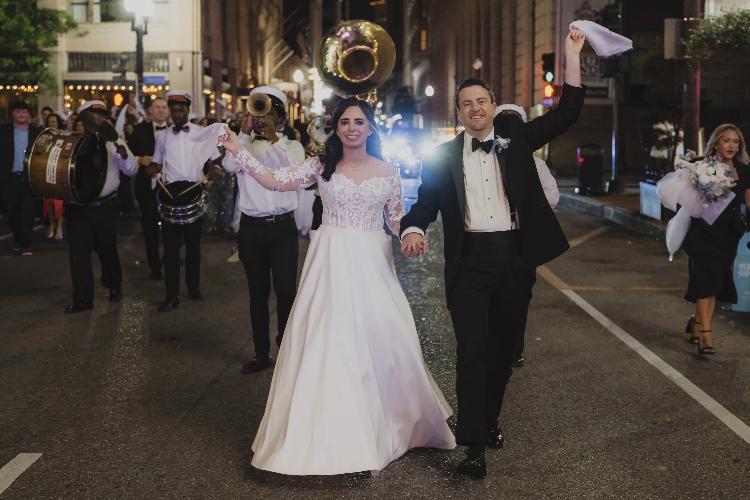 Newlyweds lead a lively nighttime second line through the streets of New Orleans.