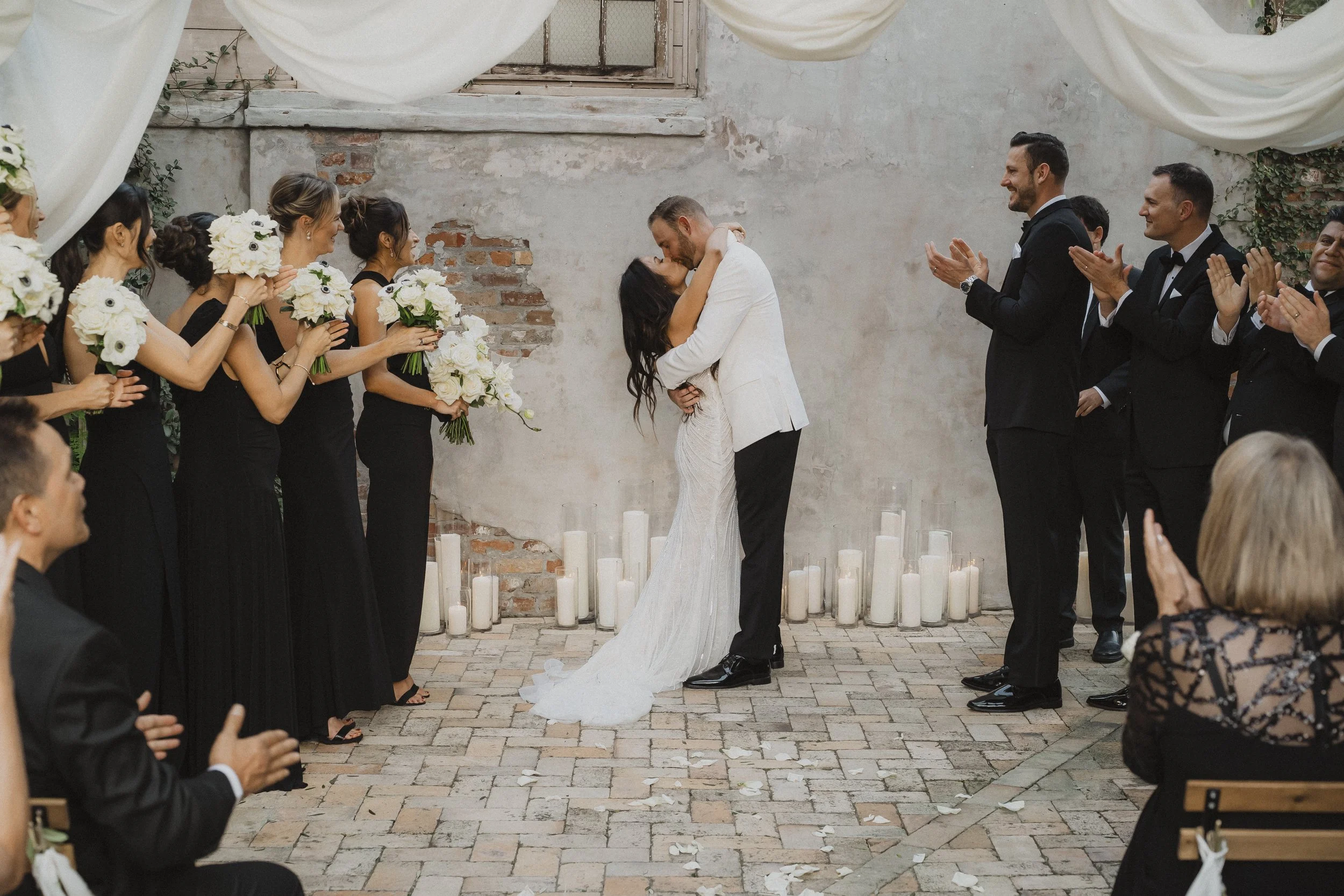Newlyweds walking back up the aisle as their guests celebrate