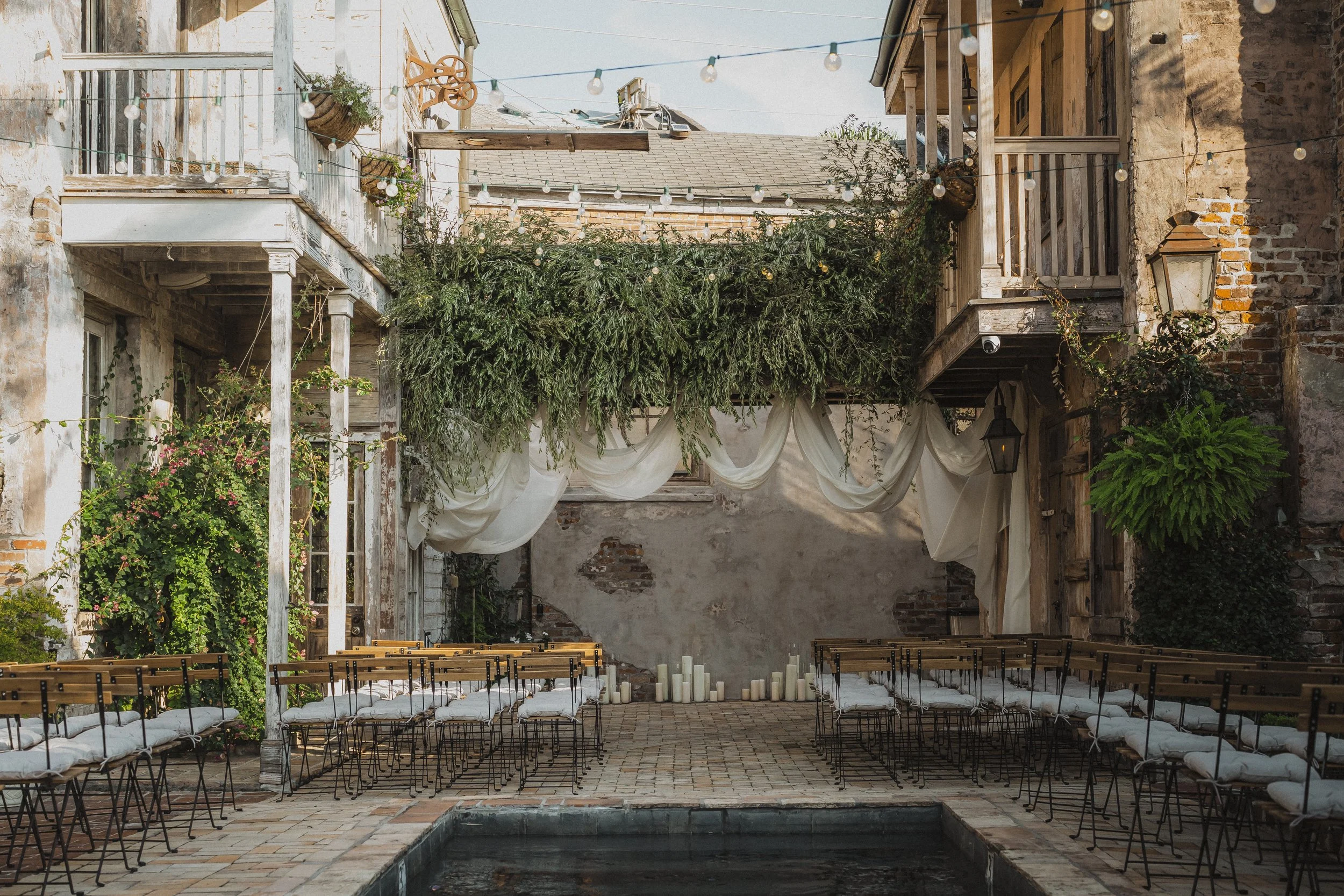 Courtyard ceremony setup beside the pool at Race + Religious in New Orleans