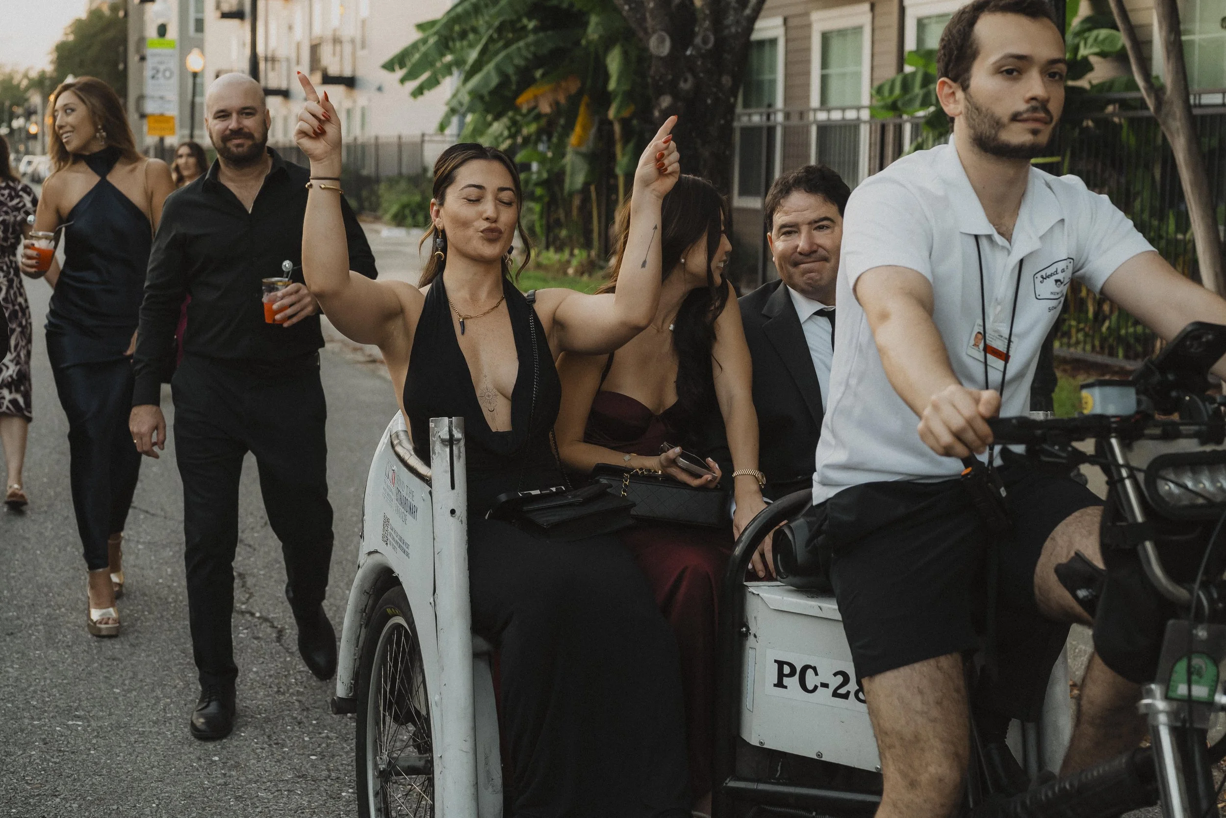 Wedding guests dancing through the street during a New Orleans second line