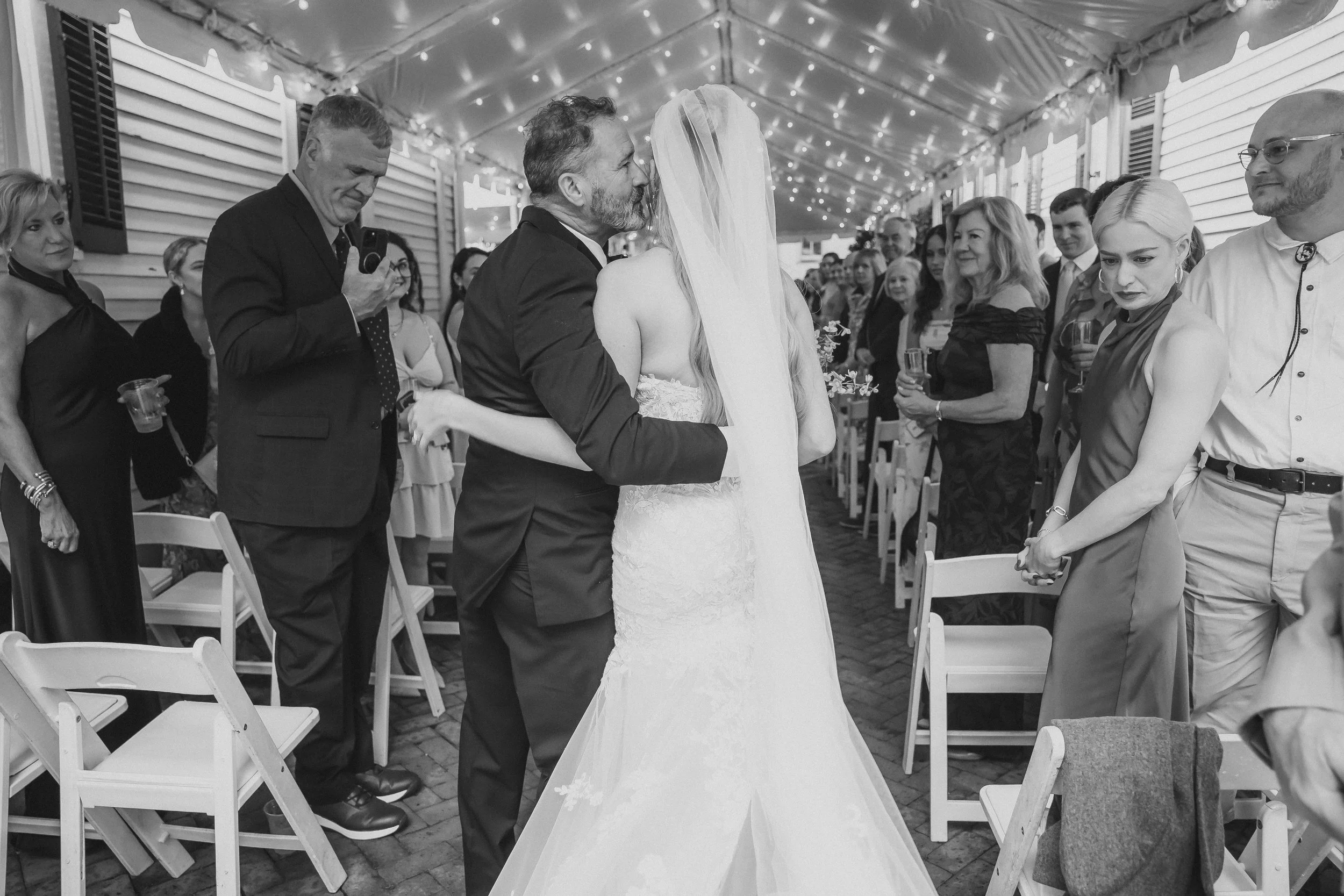 Bride and groom meet at the end of the aisle during their wedding ceremony.