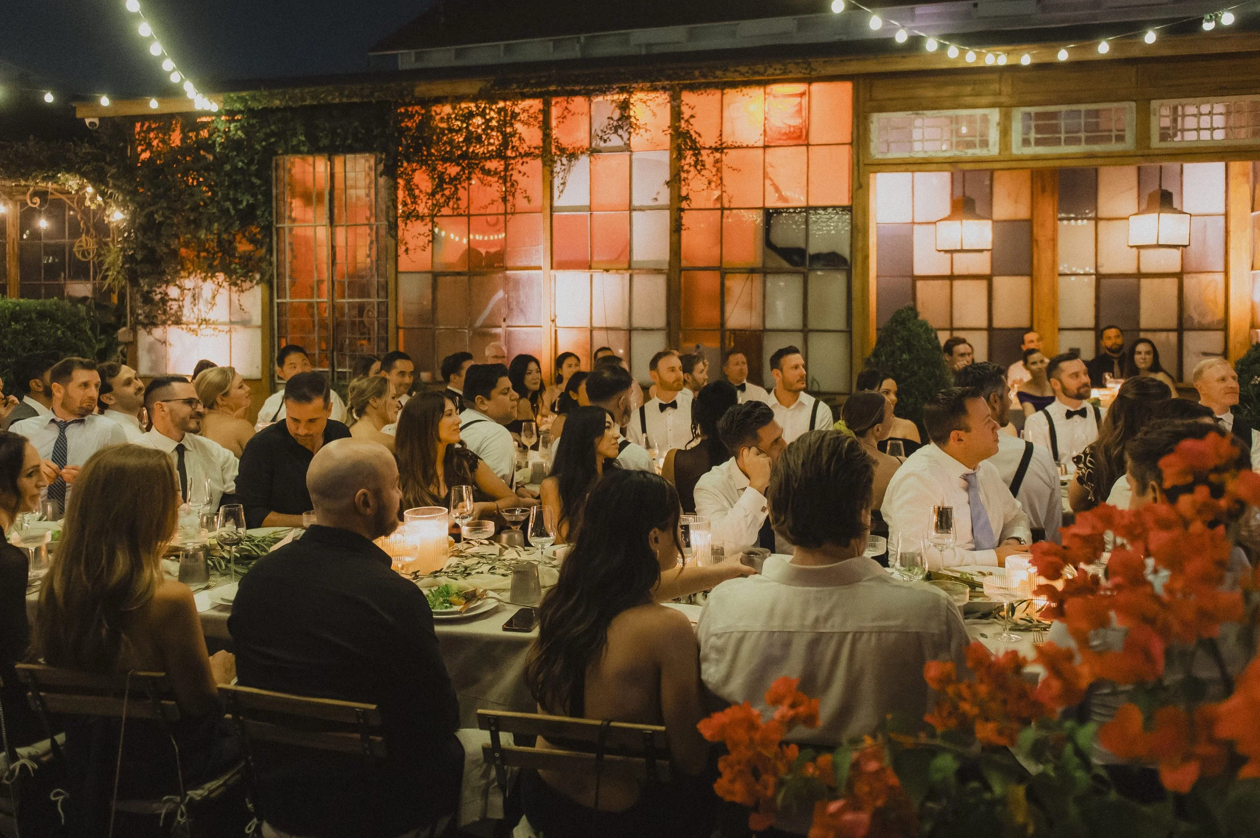 Guests seated for an evening reception in the Race + Religious courtyard