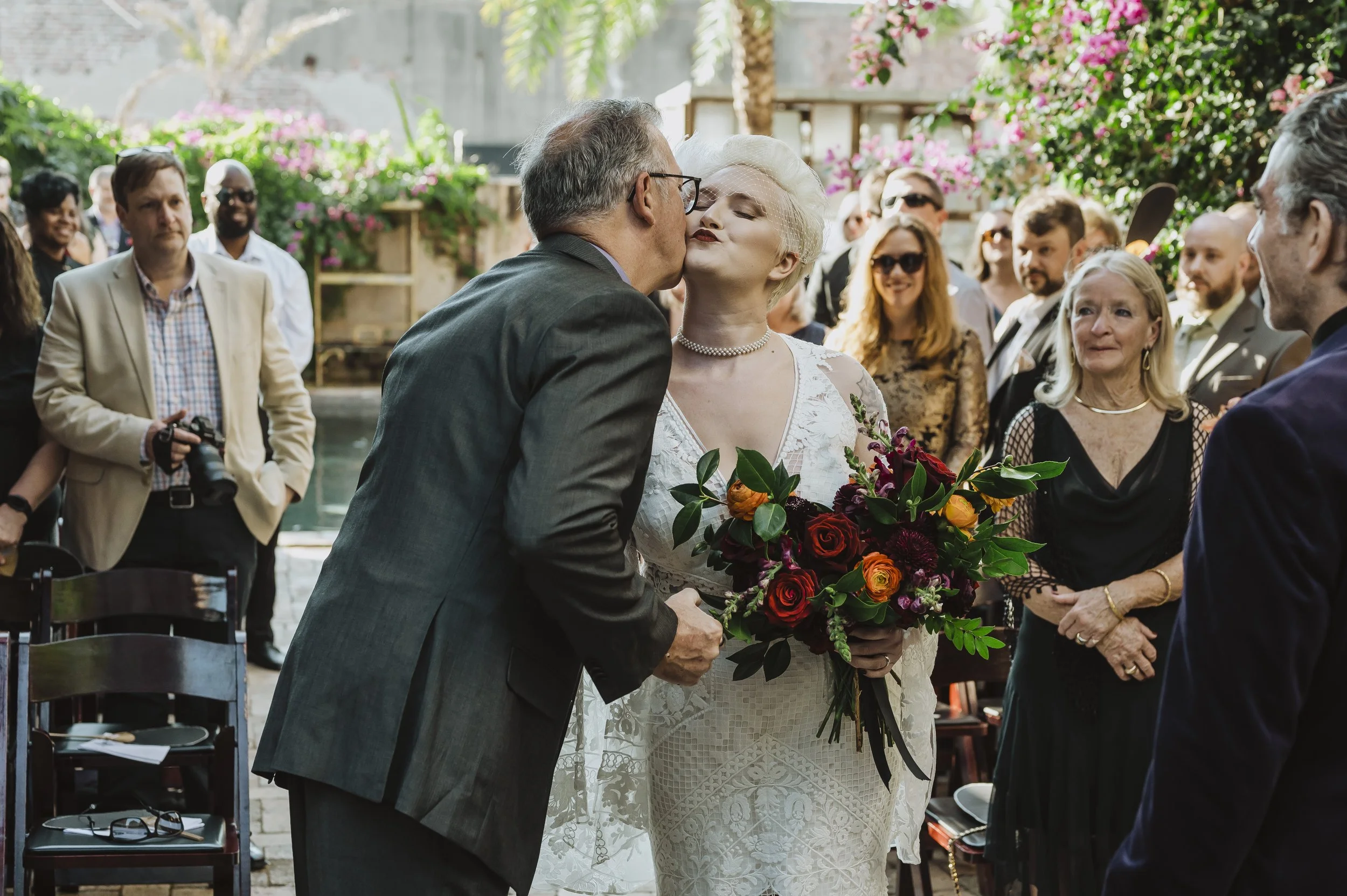 Couple surrounded by guests during their Race + Religious wedding ceremony