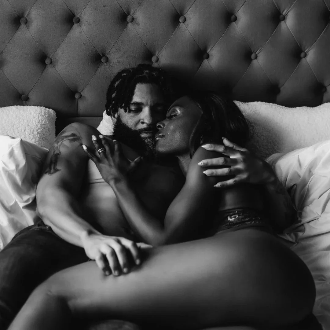 black couple embracing on bed in lingerie