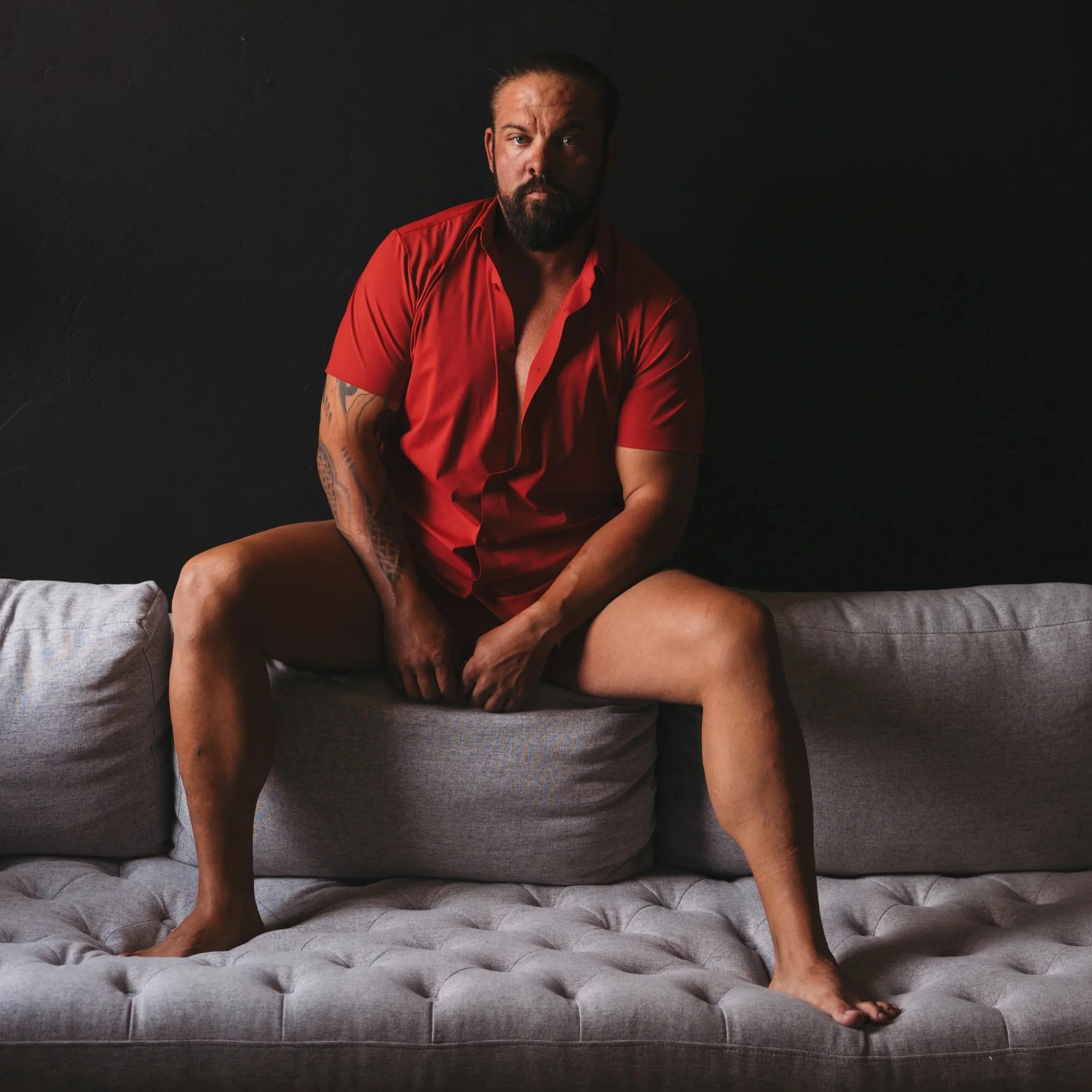 Man embracing confidence in men's boudoir session at Unleashed Boudoir Tucson