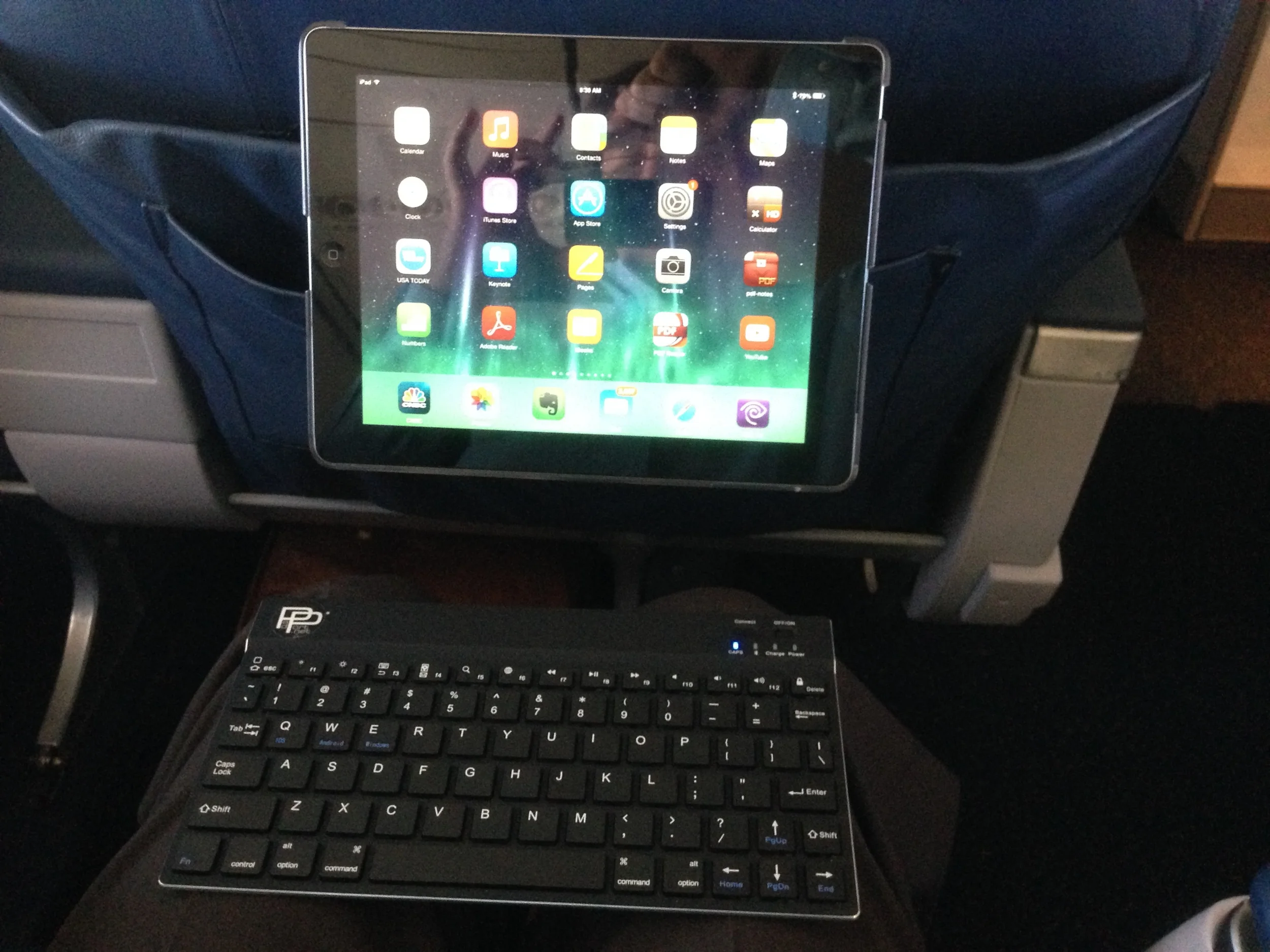 PadStand, positioned on seat back in use with a bluetooth keyboard.