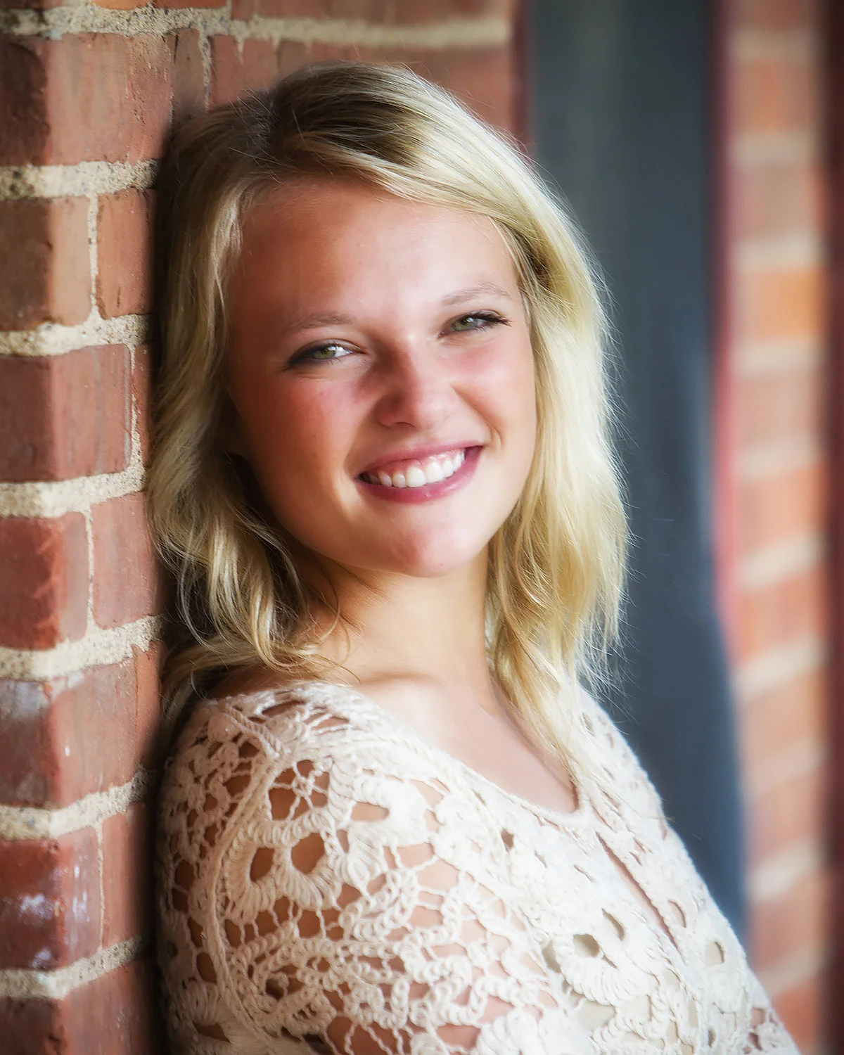 Senior leaning on wall.