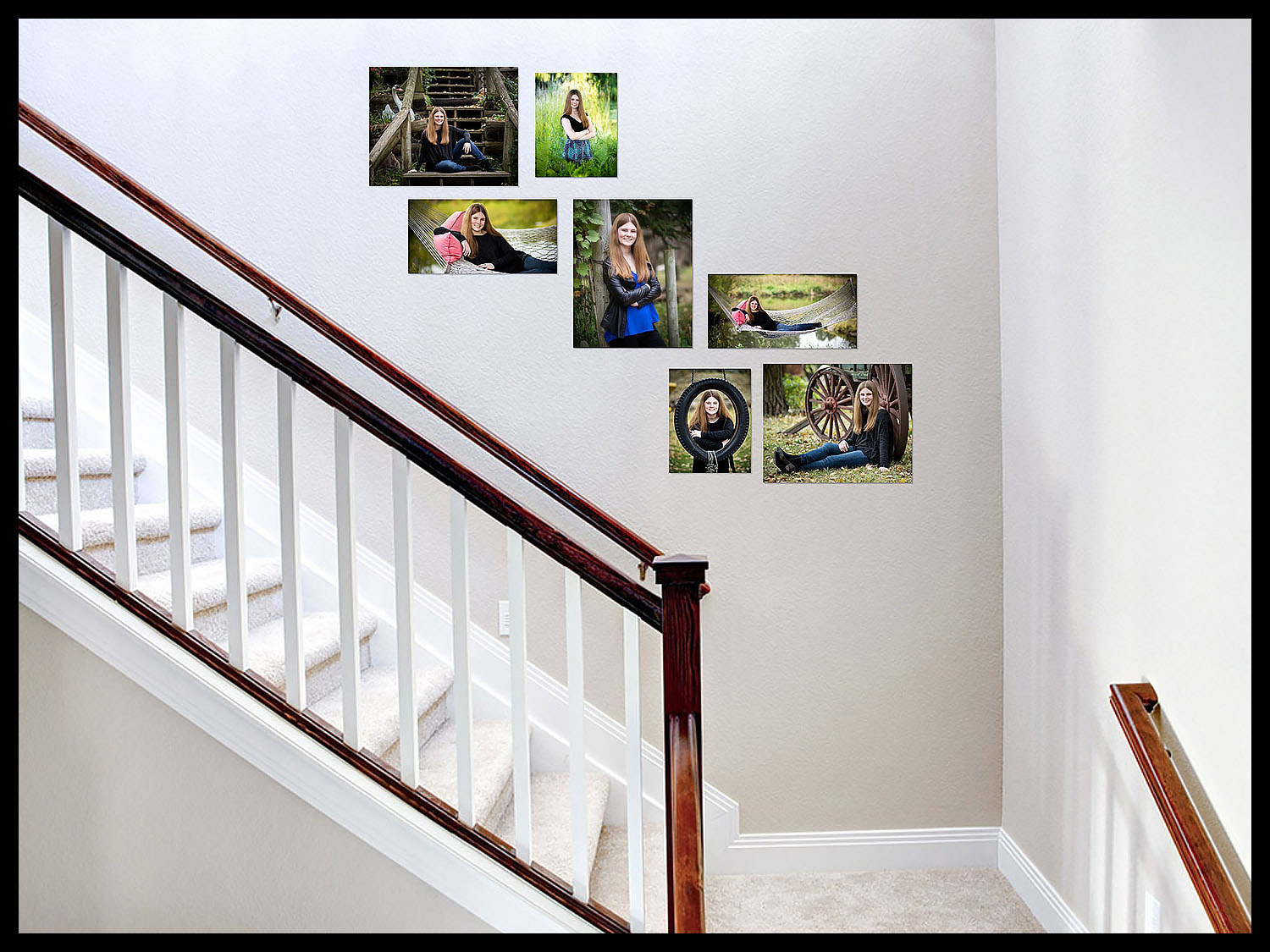 Senior portraits displayed over staircase.