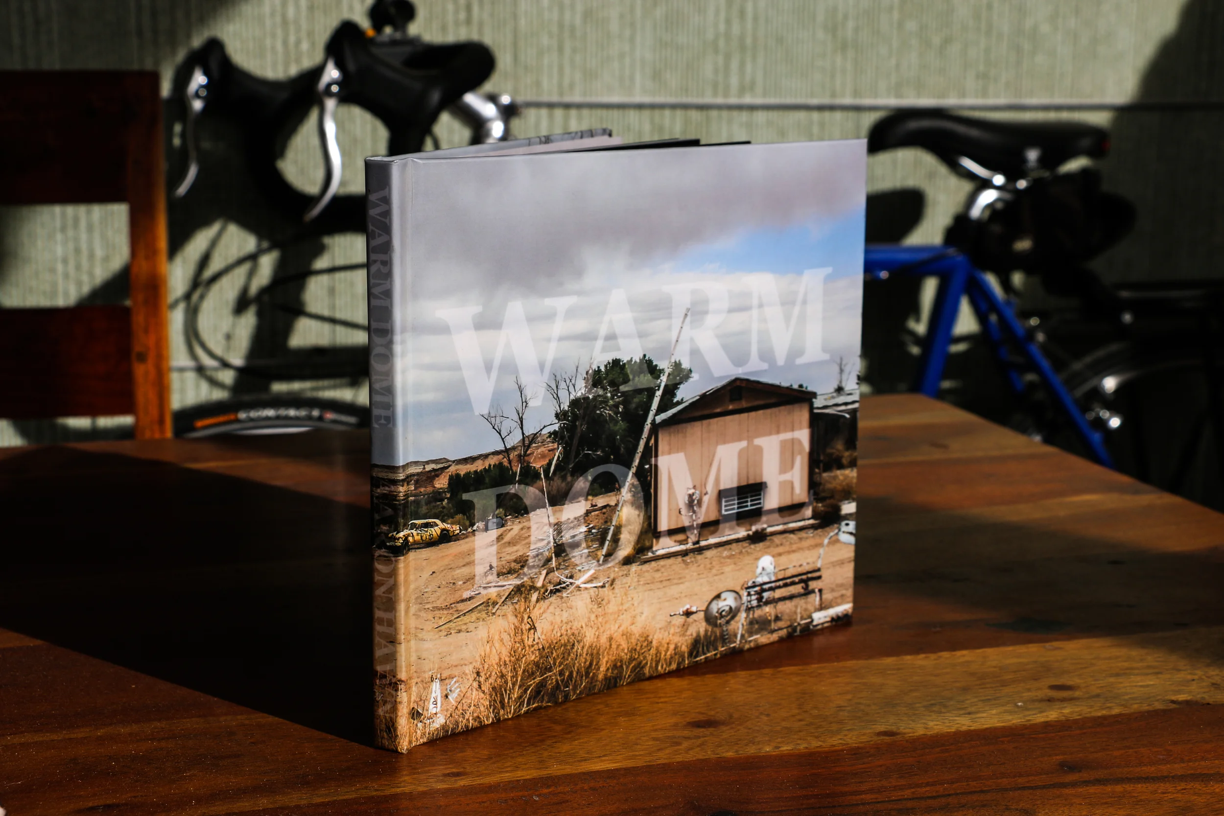 WARM DOME A photo documentary of the rarely seen back roads of Louisiana and Texas. Taken on a 1331 mile bike ride in the spring of 2012. 80 Pages. 1st Edition. Hardcover. Special order at http://www.blurb.com/b/3784215-warm-dome . Paperback coming in 2014.