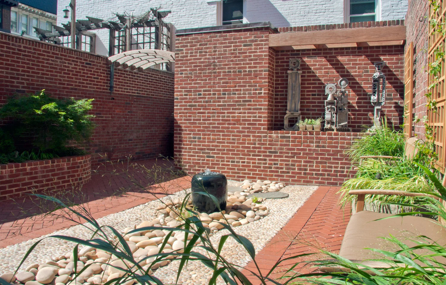 Project Location: Washington, DC (Logan Circle) Completion: Winter 2010 General Contractor: Redux Garden & Home Primary Material Palette: permeable clay pavers, black granite (fountain), antique granite (planters), ipe, river rock, stainless steel, aluminum sculptures, western red cedar trellis Photos By: Moody Landscape Architecture