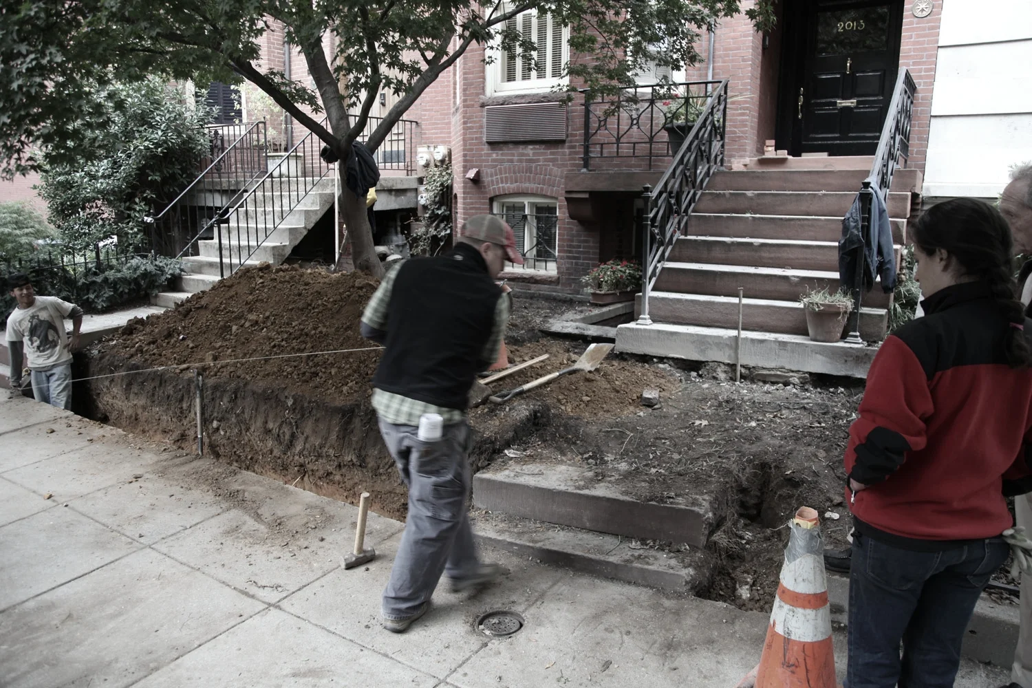 Front garden demolition and preparation for new brick retaining wall, new metal fence, new stone cheek walls, new custom handrail to match historic finials, and new stone step to match historic brownstone
