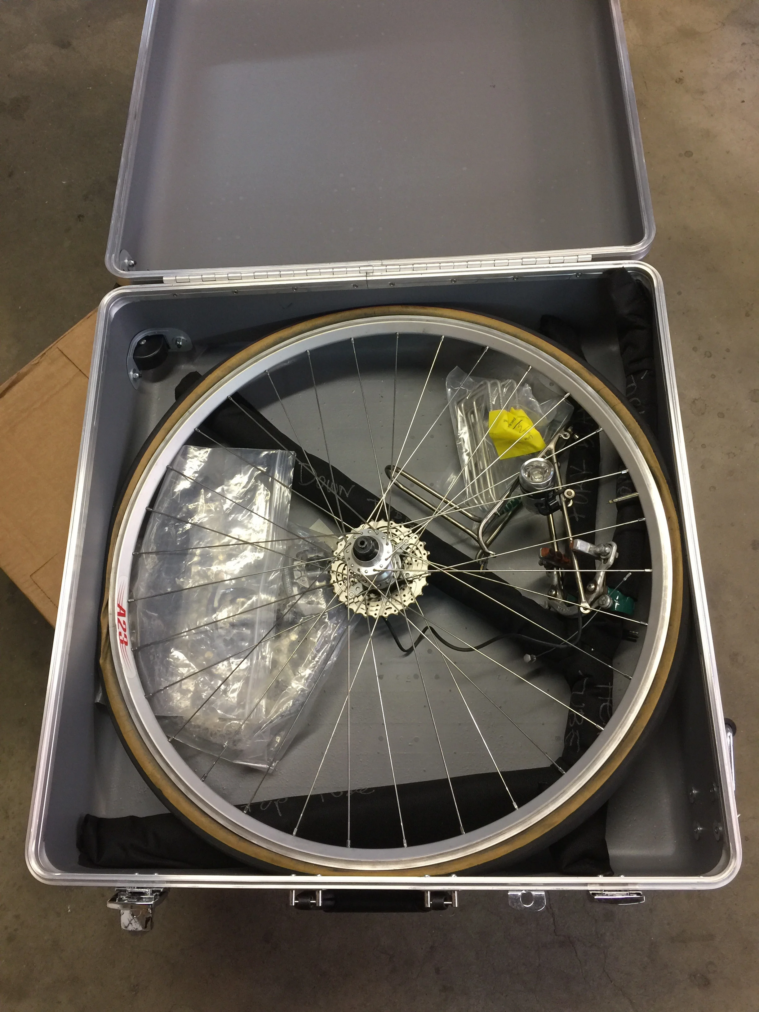 Rear wheel, cassette side down, tire deflated. Don't forget to remove the skewers, won't work otherwise. 
