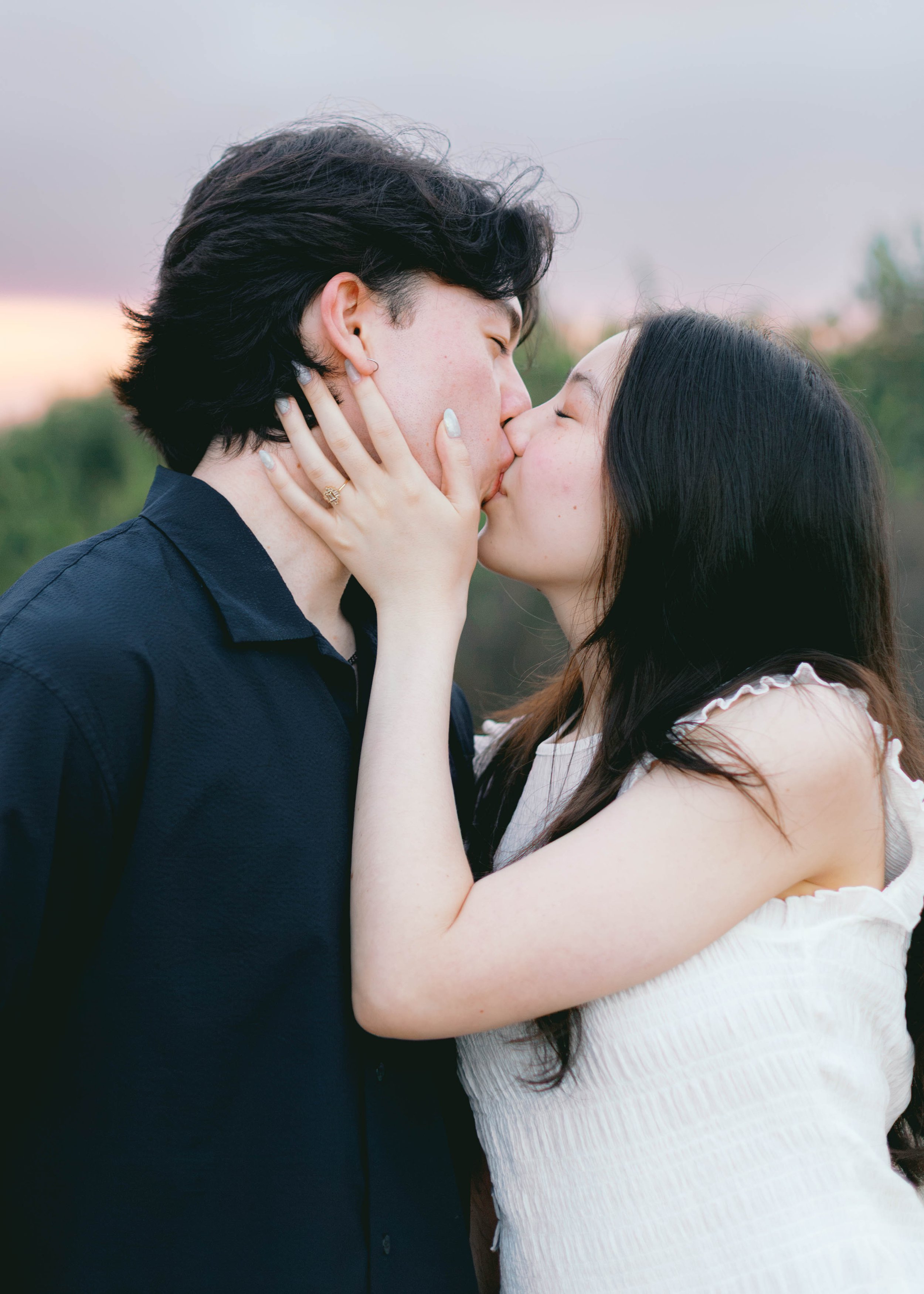 Romantic close-up of Curtis and Eimi kissing after their surprise proposal.
