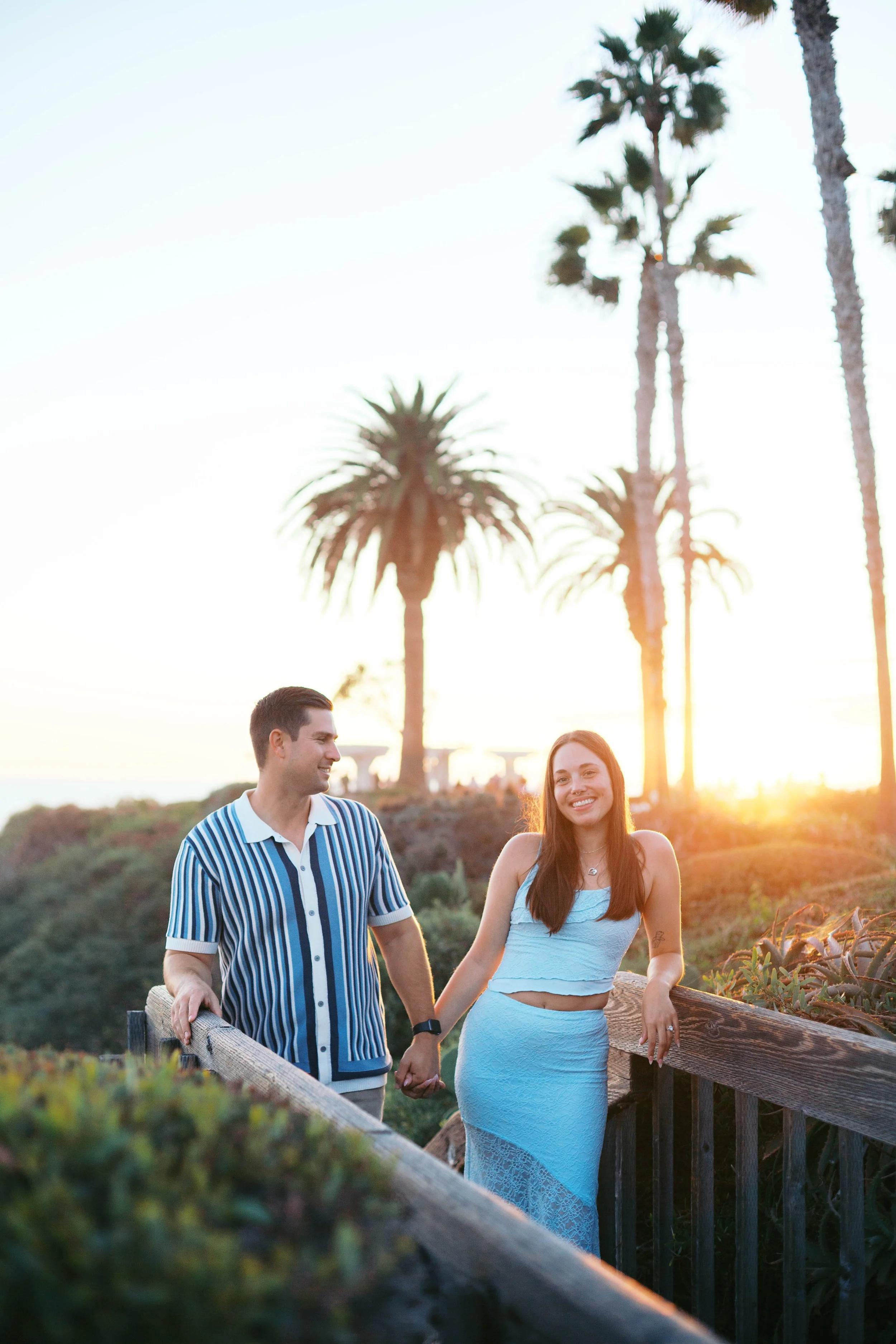 Candid sunset engagement photos near Treasure Island Beach after a Laguna Beach surprise proposal.