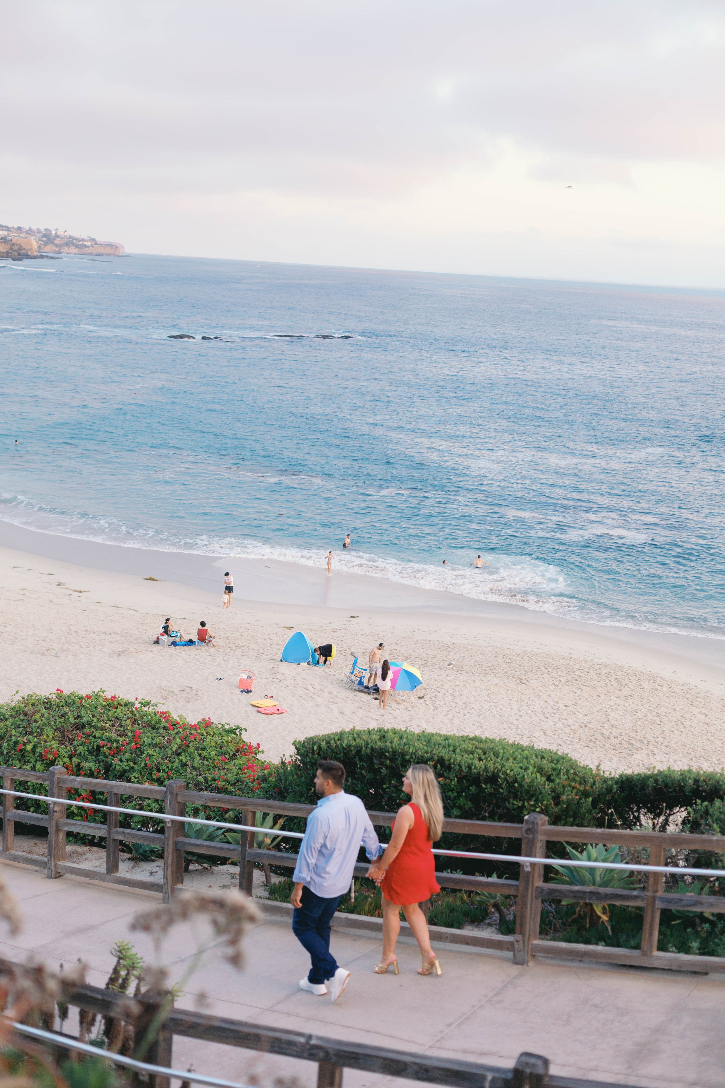 Newly engaged couple overlooking Treasure Island Beach during their Laguna Beach proposal photography session.