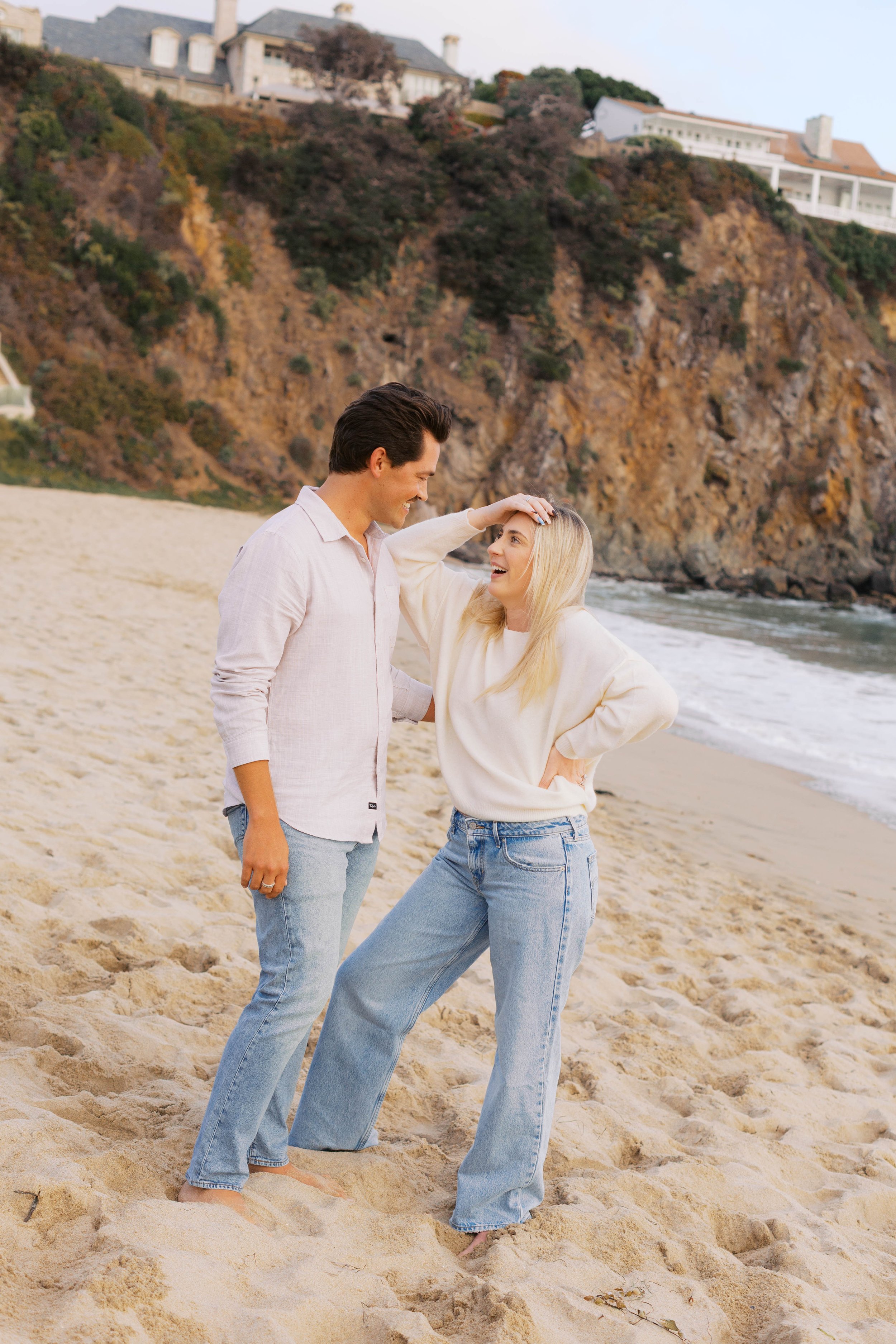 Joyful candid moment after a surprise proposal at Emerald Bay, captured by Laguna Beach proposal photographer Alissa Noelle Photography.