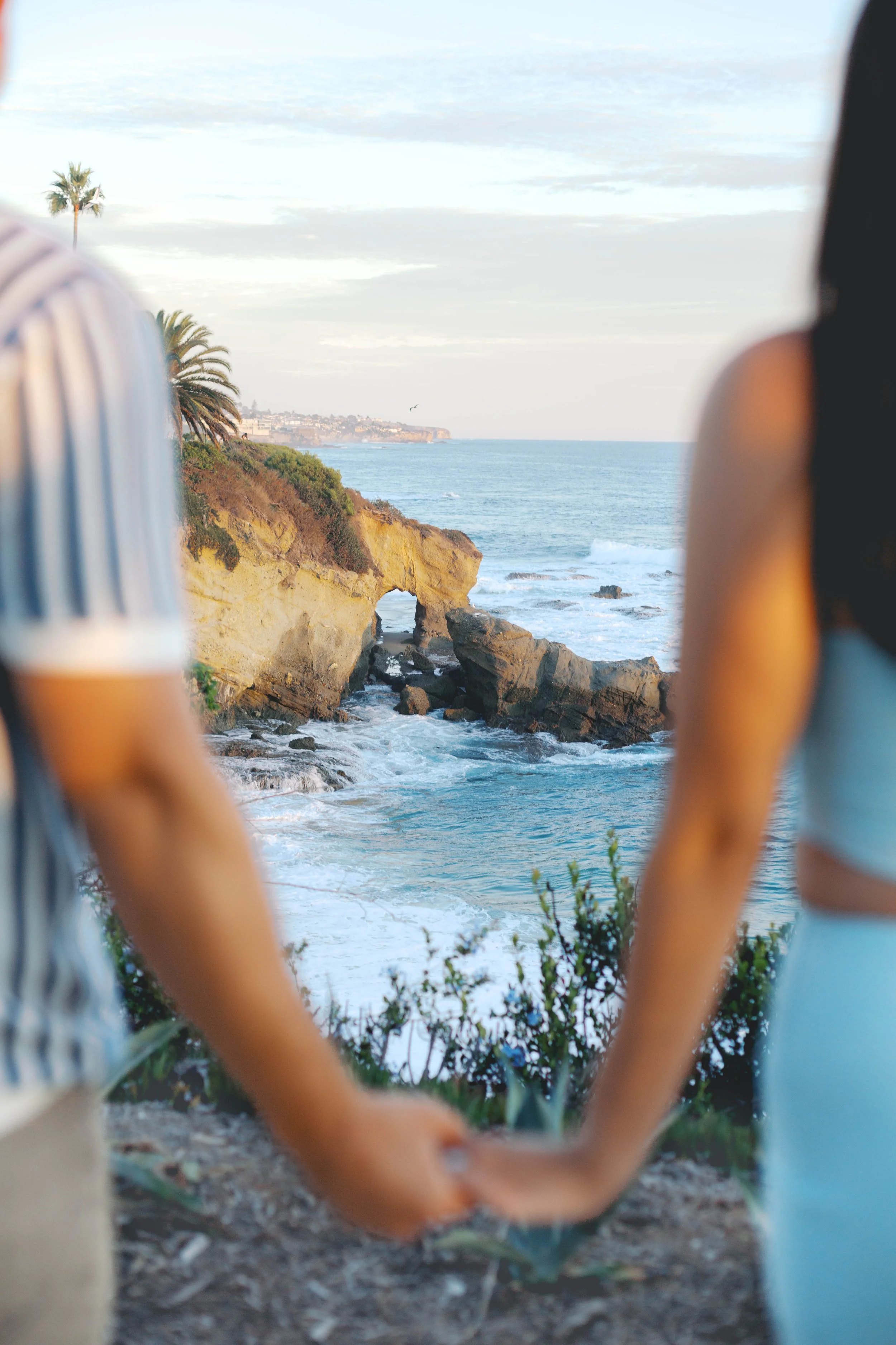 Newly engaged couple enjoying the coastal views after their Treasure Island Beach proposal in Laguna Beach, California.