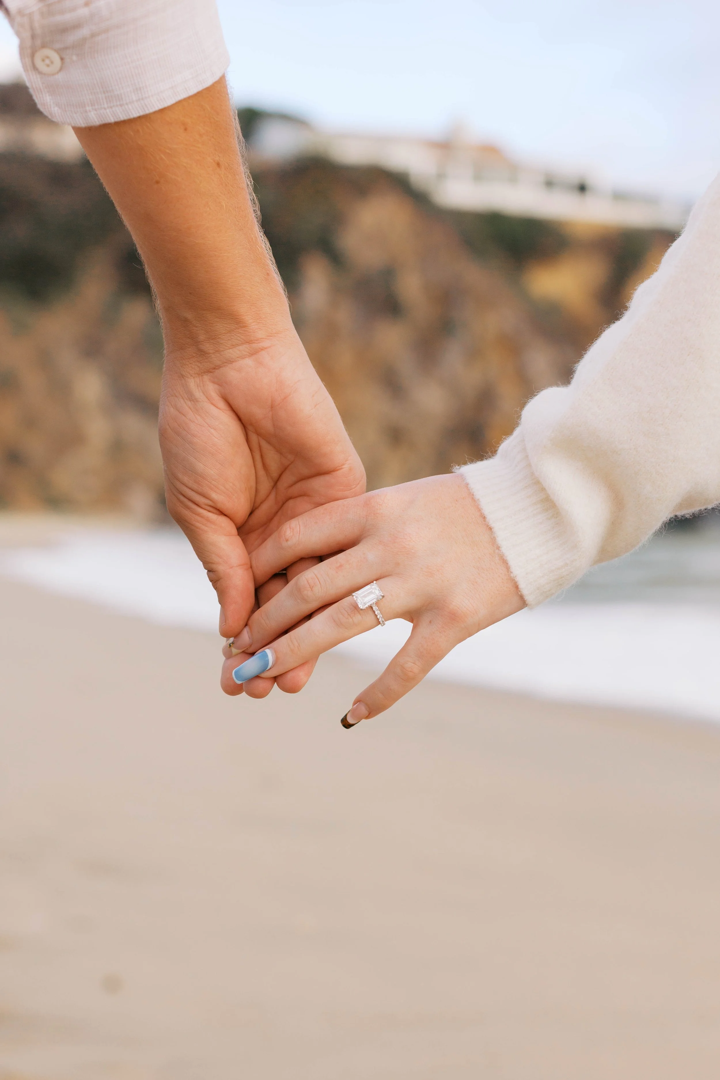 Close-up engagement portrait showing the bride-to-be’s ring after a Laguna Beach proposal, photographed by Alissa Noelle Photography.