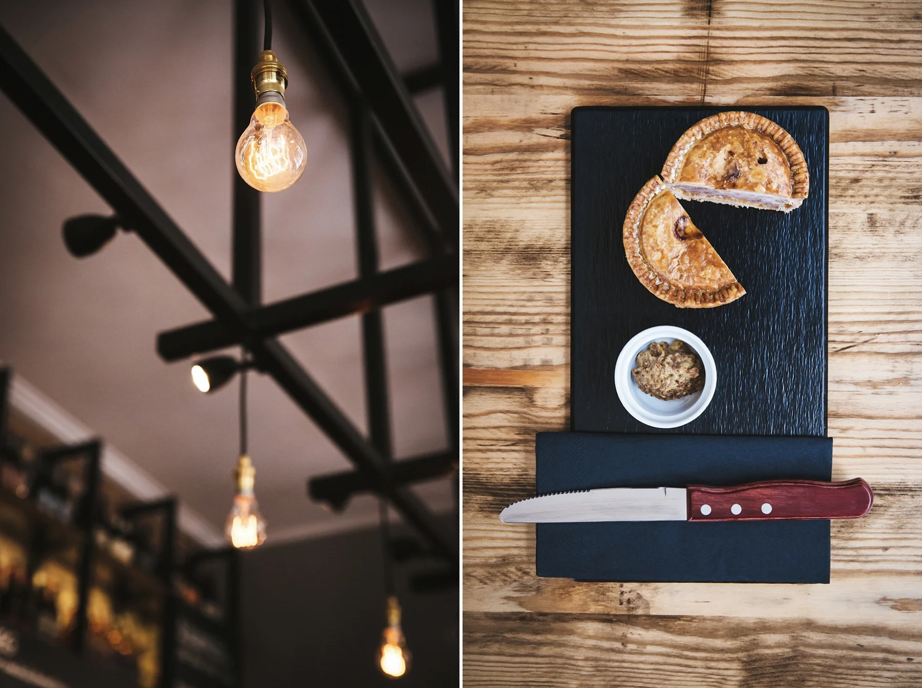 A hanging industrial-style light bulb on the ceiling on the left, and a top view of a wooden table with two slices of pie on a black rectangular plate, a small bowl of spread, a black napkin, and a bread knife with a red handle.