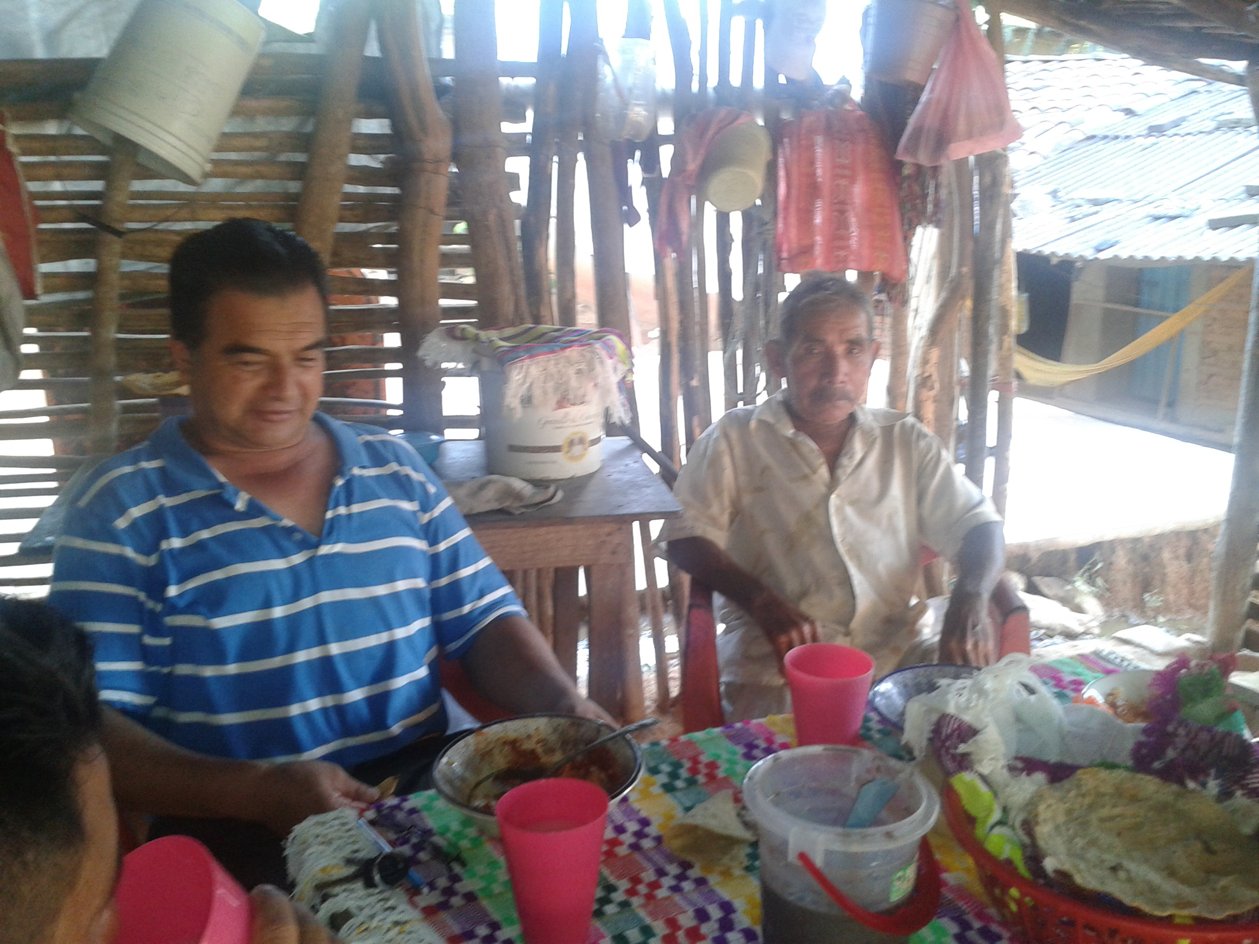  Norberto, left, and the pastor, eating at a home in&nbsp; La Hierba Santa  