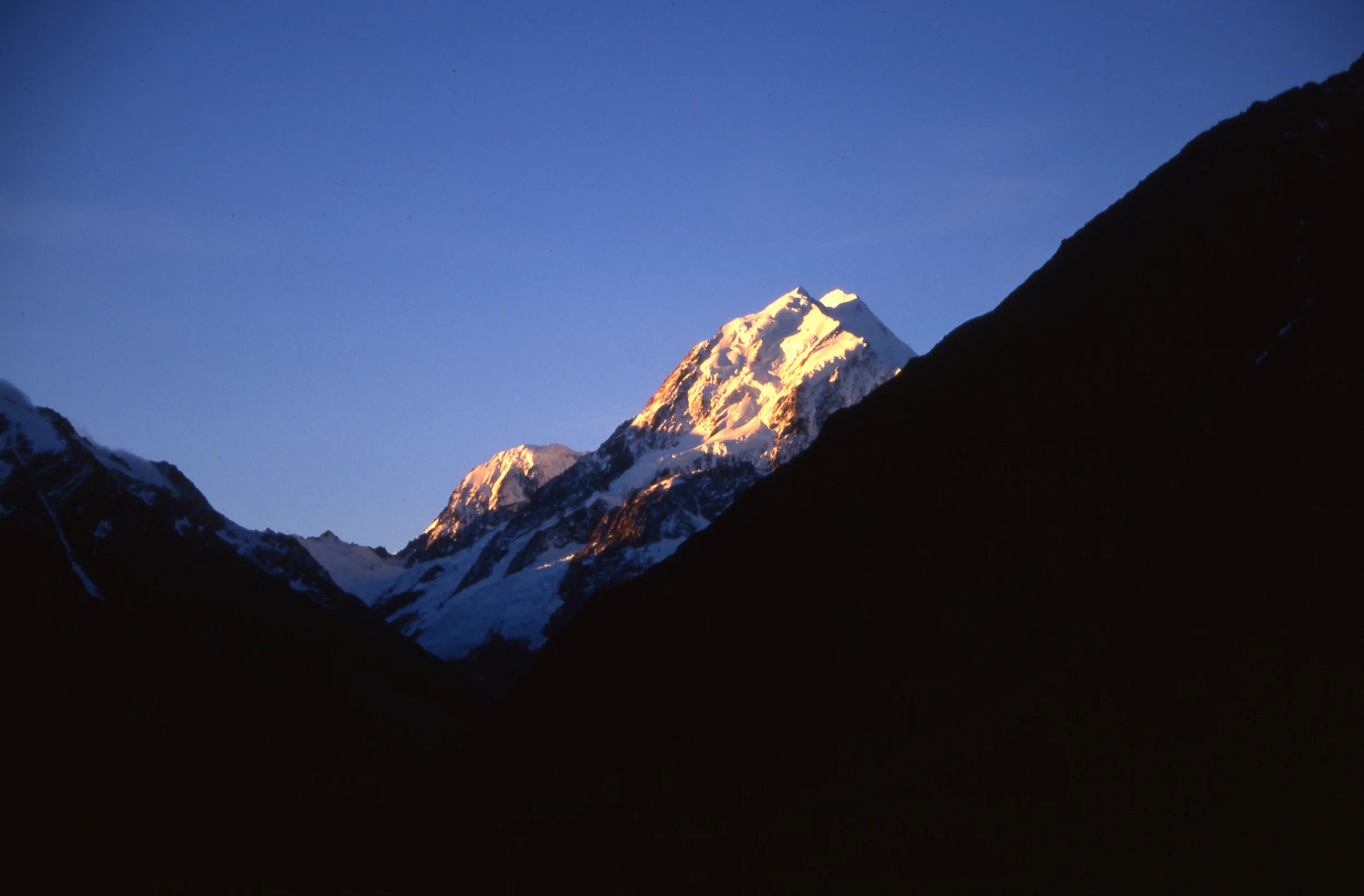 Mt. Cook showing the low, middle and high peaks, and Mt. Hicks (left) from the south/village, 1998.