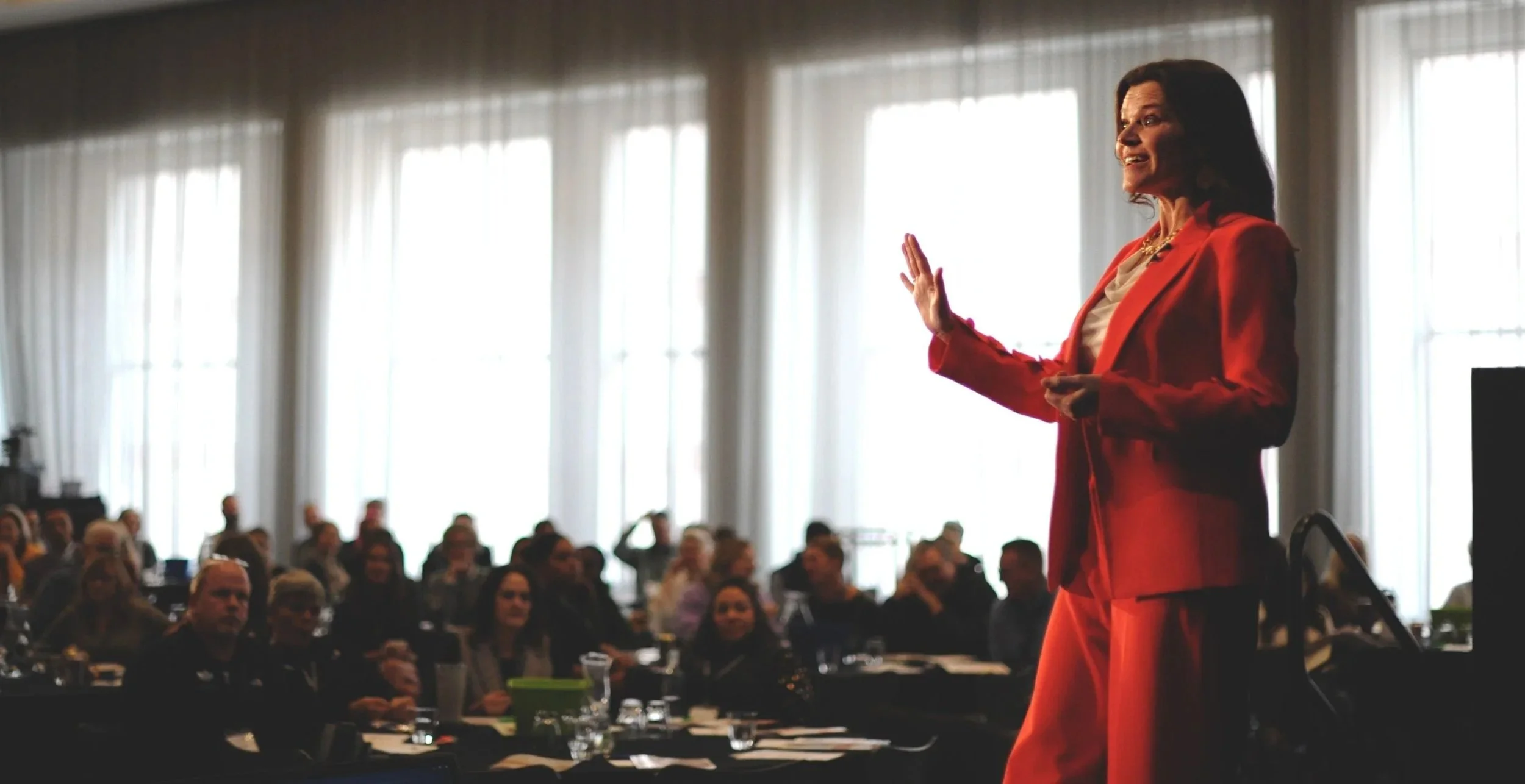 Leadership keynote speaker Sarah Ciavarri presenting to a large conference audience.
