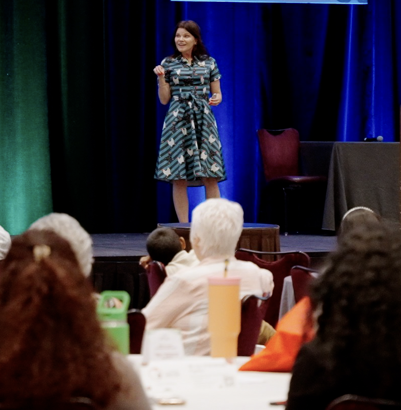 Sarah Ciavarri speaking to an audience from a conference stage.