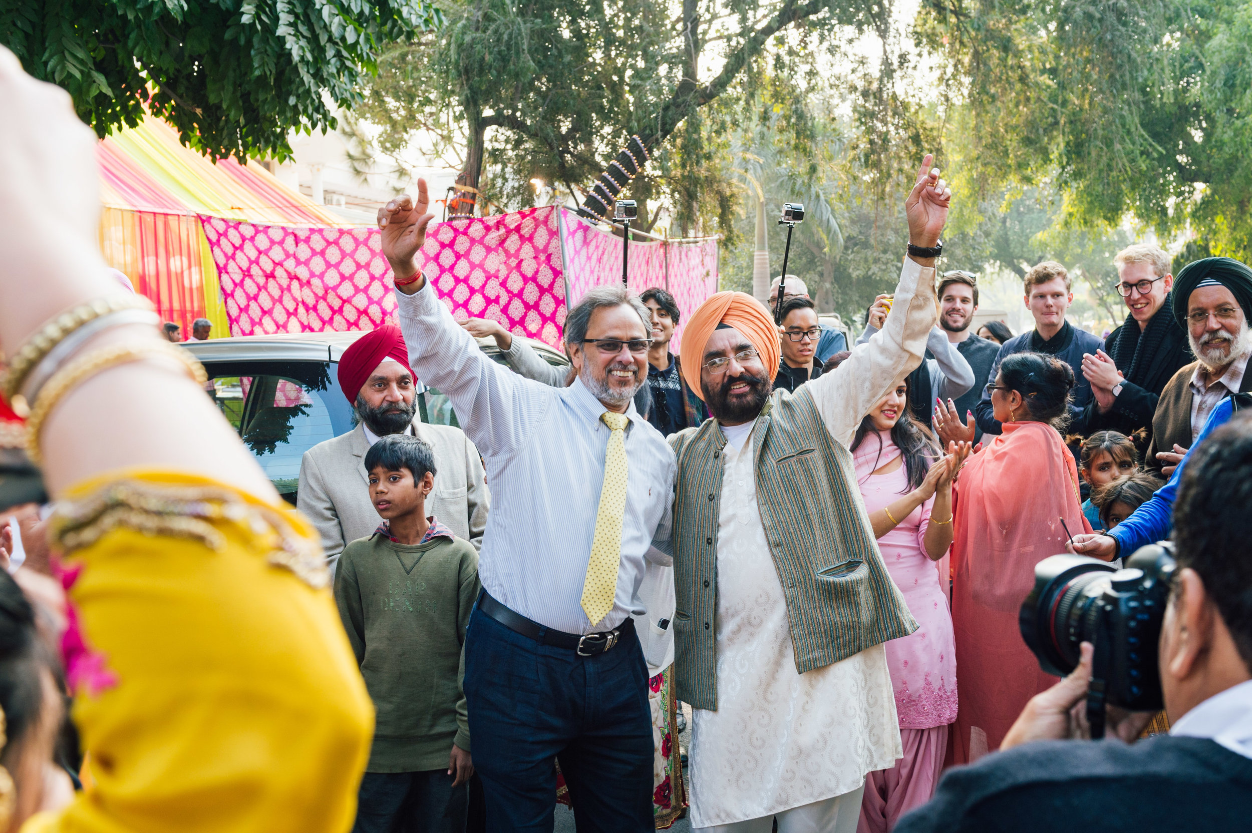  Bride and groom fathers having a ball of a time dancing in the streets outside their the groom's home.&nbsp; 