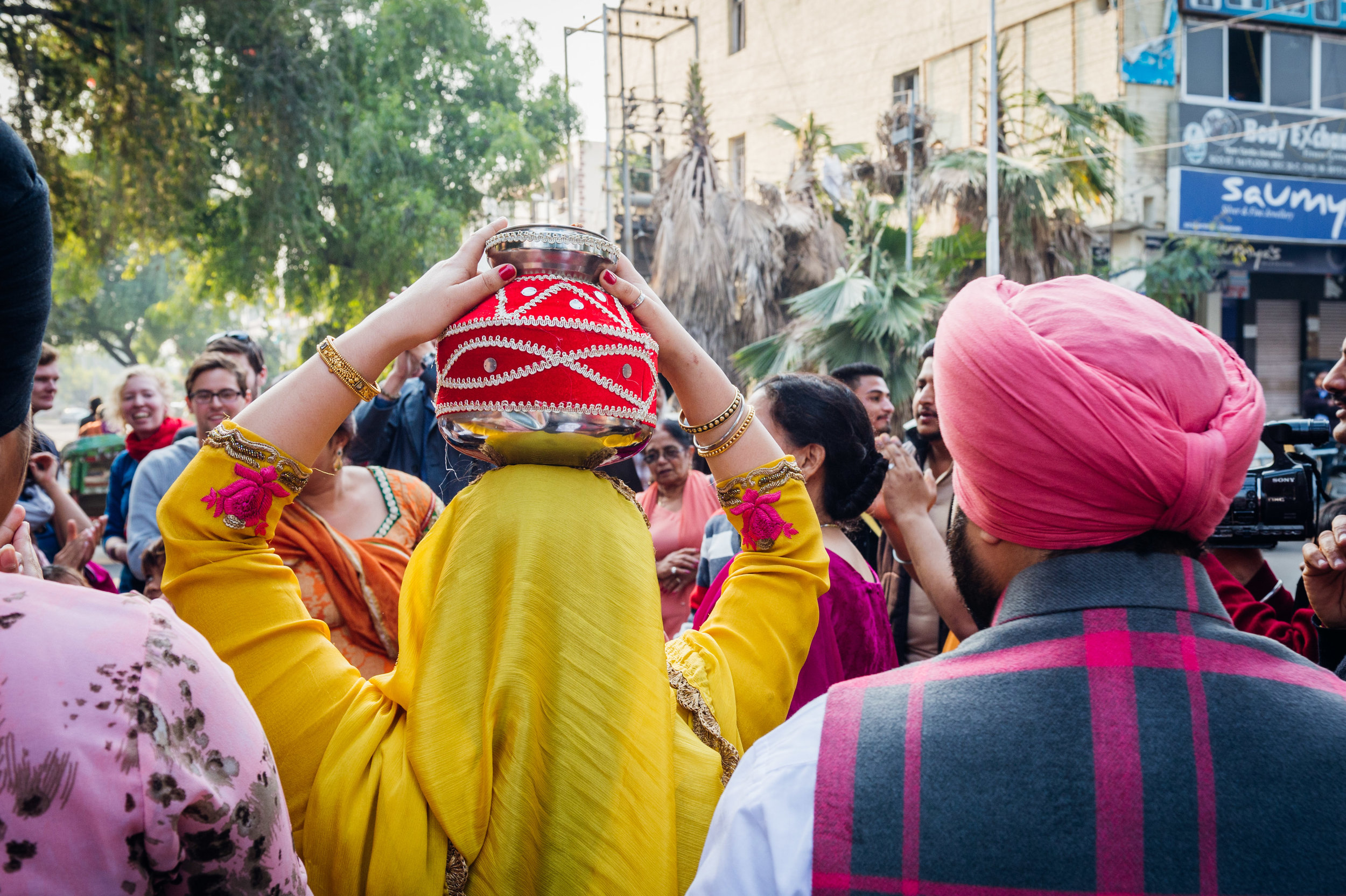  A female relative carries the Gharoli on her heading walking towards the Gurudwara. 