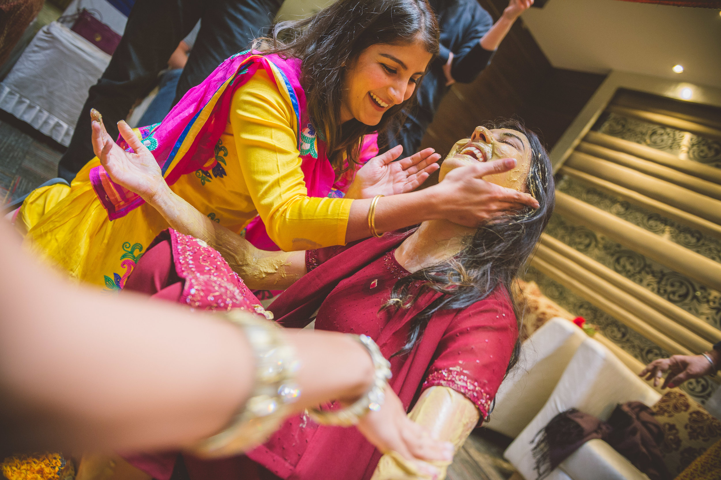  Guests of the bride having a great time smearing paste on the bride. 