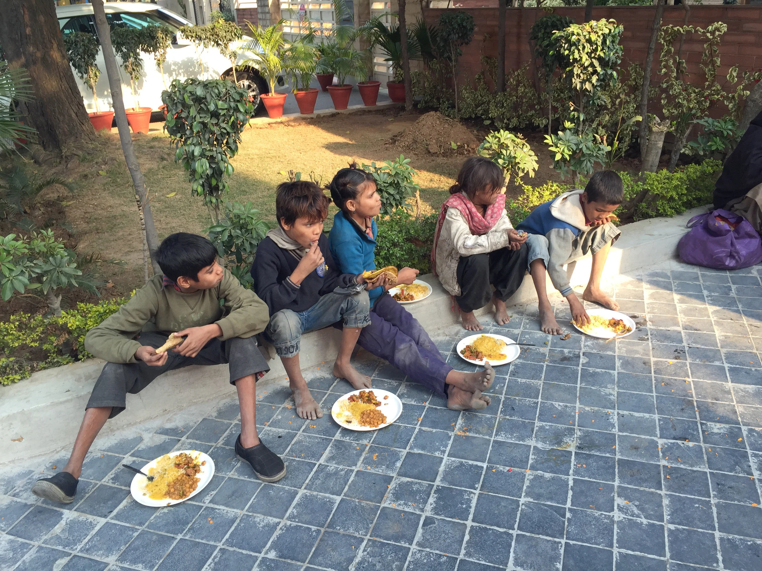 Underprivileged kids given hot food to eat. (Image taken with iPhone 6+)