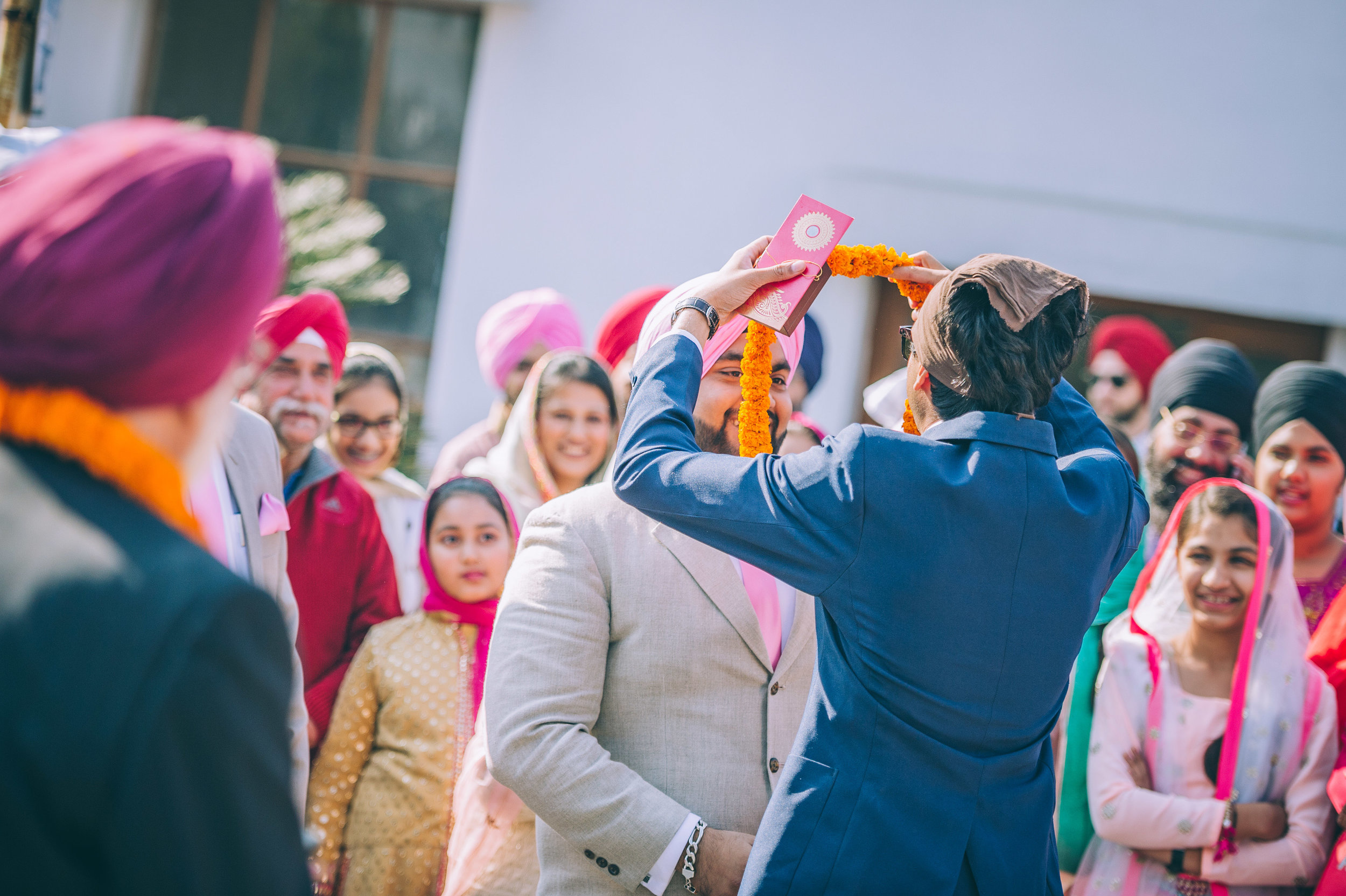  This picture shows the youngest in both families trying to put a haar on each other. 