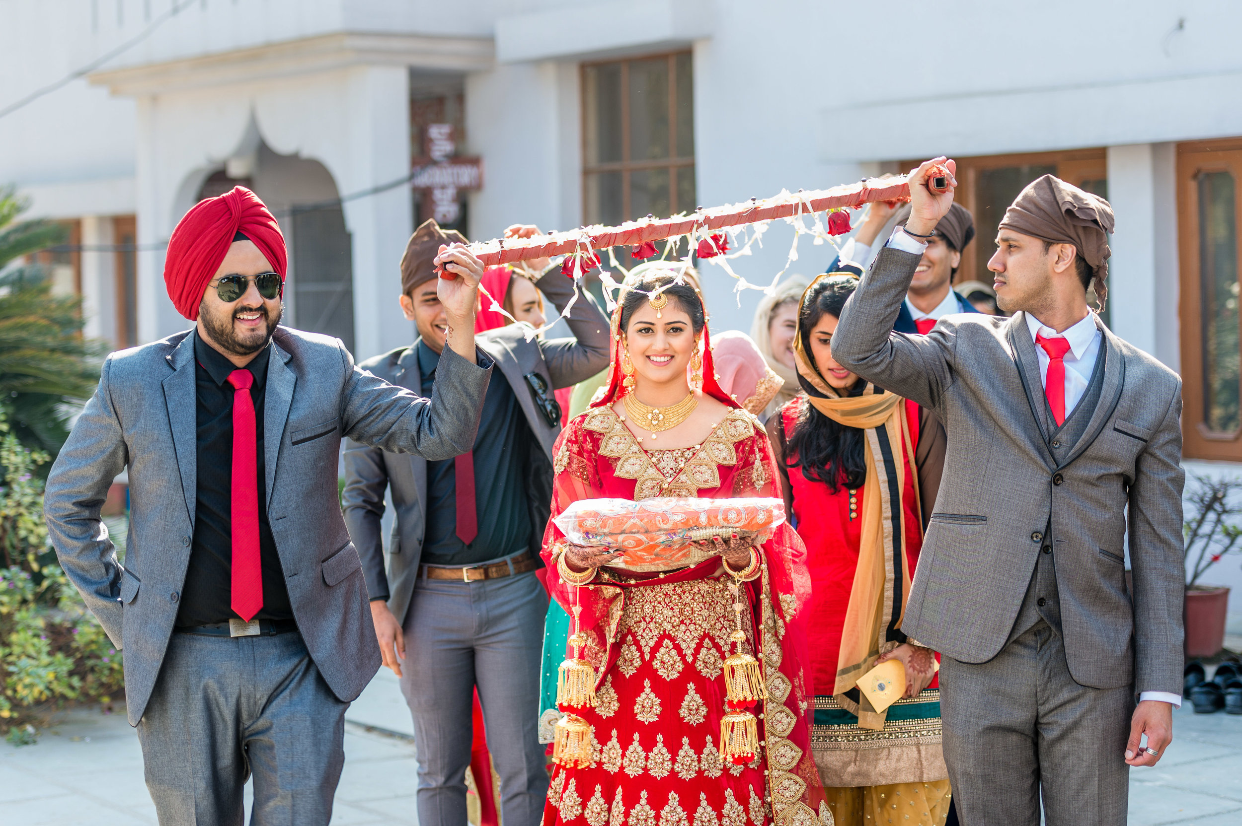  The lovely bride being escorted by her brothers into the gurdwara darbar. This is a symbolic sight because brother in the Indian culture are considered as protectors. 