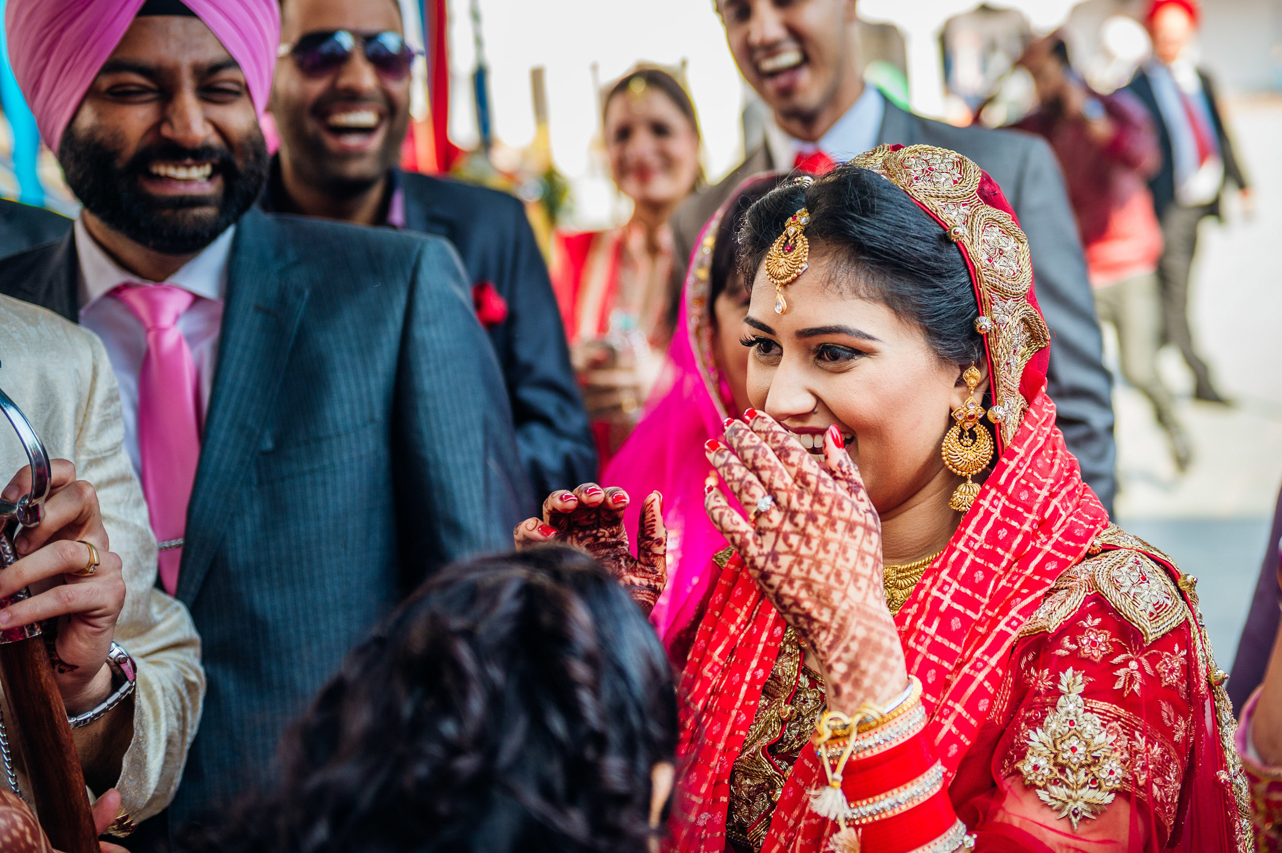  In this image, the family members of the bride and the bride herself are actually negotiating a price for the return of the groom's shoes which was taken earlier as ransom. All in good fun. 