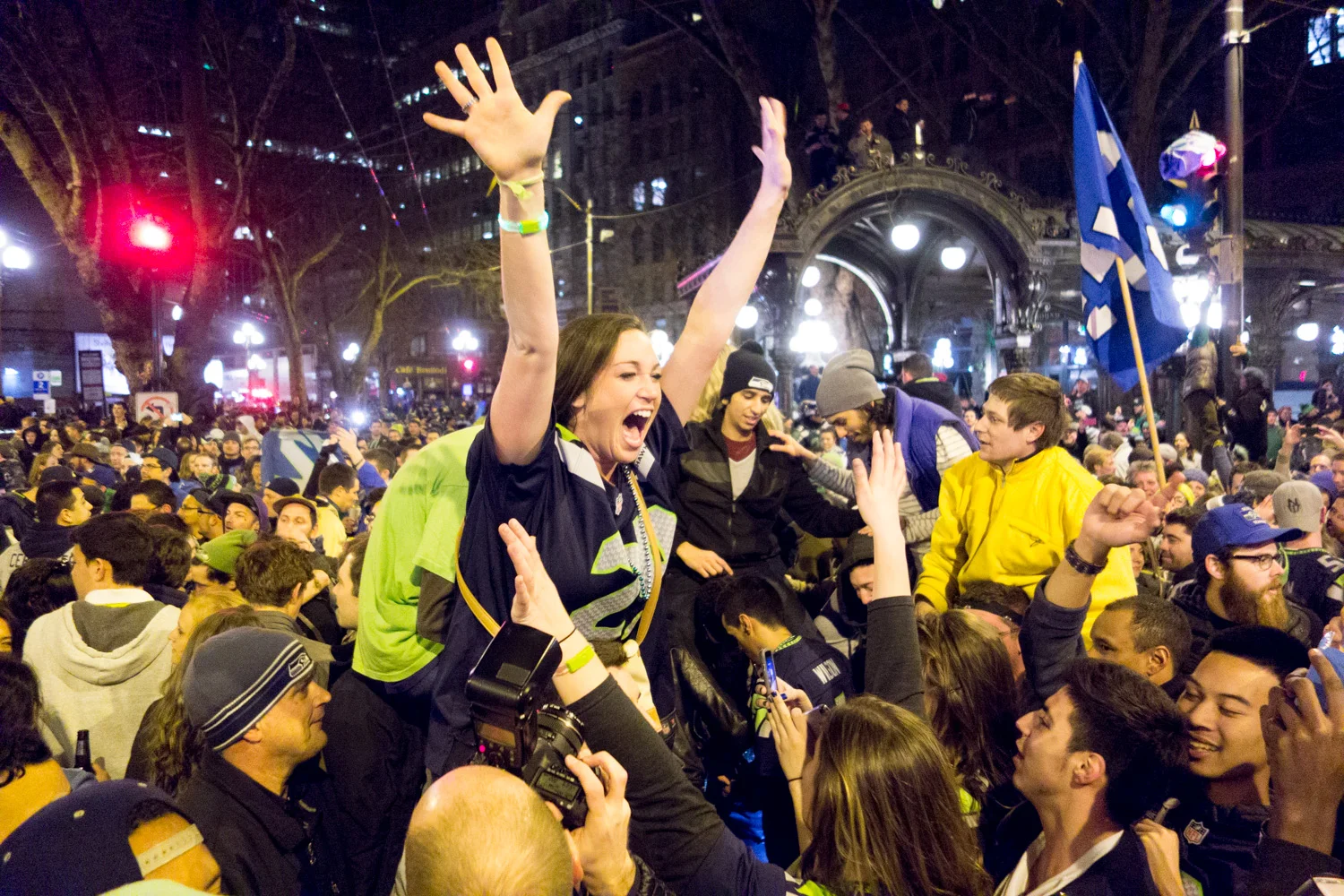 A Seahawks fan celebrates the Super Bowl win among a growing crowd in Pioneer Square.