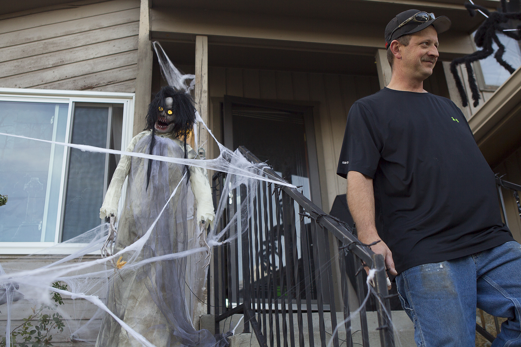 Richard Larson works Monday evening to set up his Halloween decorations. Larson says that since Halloween is the only holiday he likes to celebrate he might as well go all out.