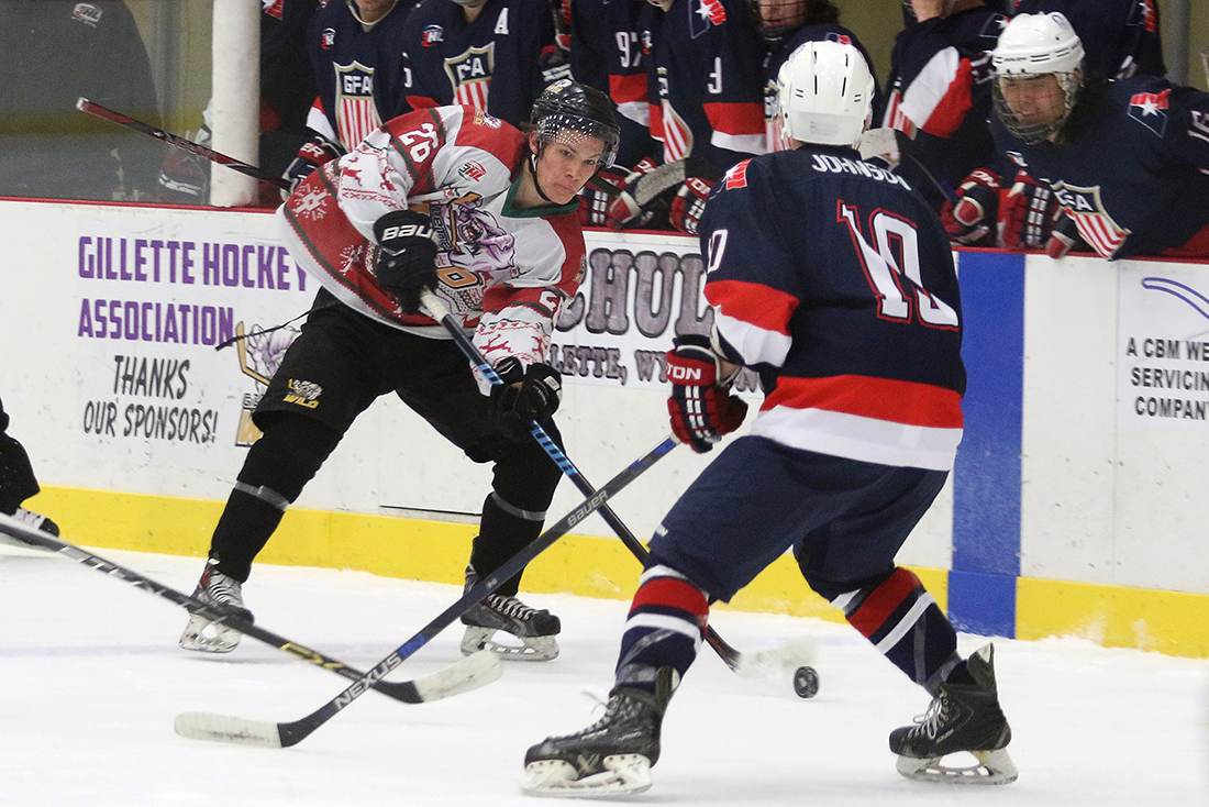 Gillette Wild defender Brett Kramer passes the puck during the Wild's 4-2 win over the Great Falls Americans Saturday January 1, 2016 at the Spirit Hall Ice Arena.