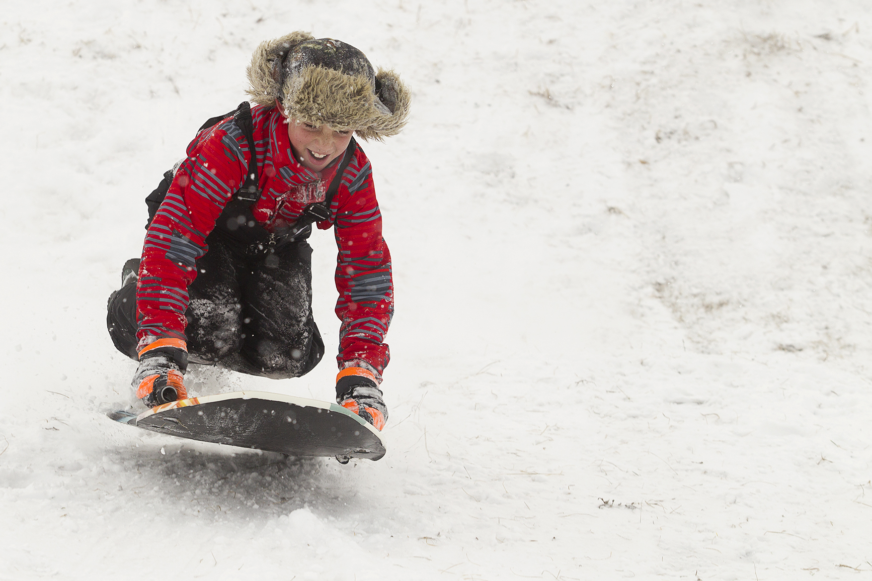 Johnathan Peel, 10, catches air while sledding Saturday at Sage Valley Junior High.