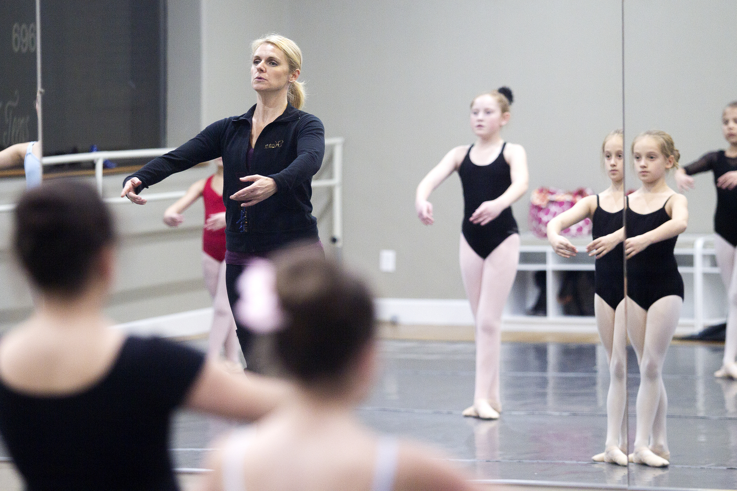 Kara Felmlee demonstrates a move to her Ballet Level 1 & 2 class Tuesday evening at Backwards and in Heels dance studio. Felmlee has been teaching the class since the program started in August.