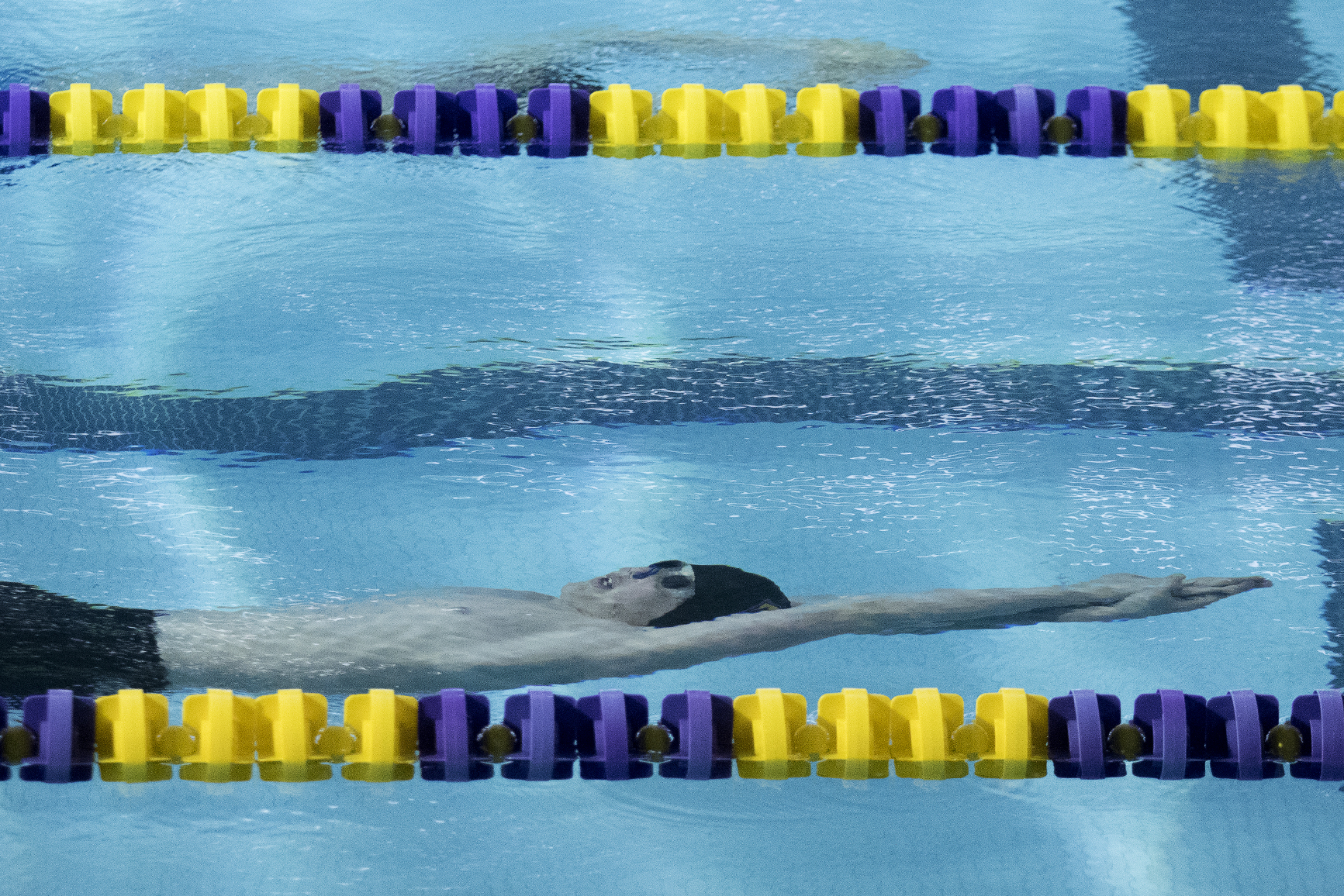 Gillette freshman JR Albers swims in the consolation heat of the 100-yard backstroke Saturday afternoon during the 4A state swim and dive championships at the Campbell County Aquatic Center. Albers finished with a time of 59.42 while fellow Camel freshman Gunnar Poley finished first in the state with a time of 53.79.
