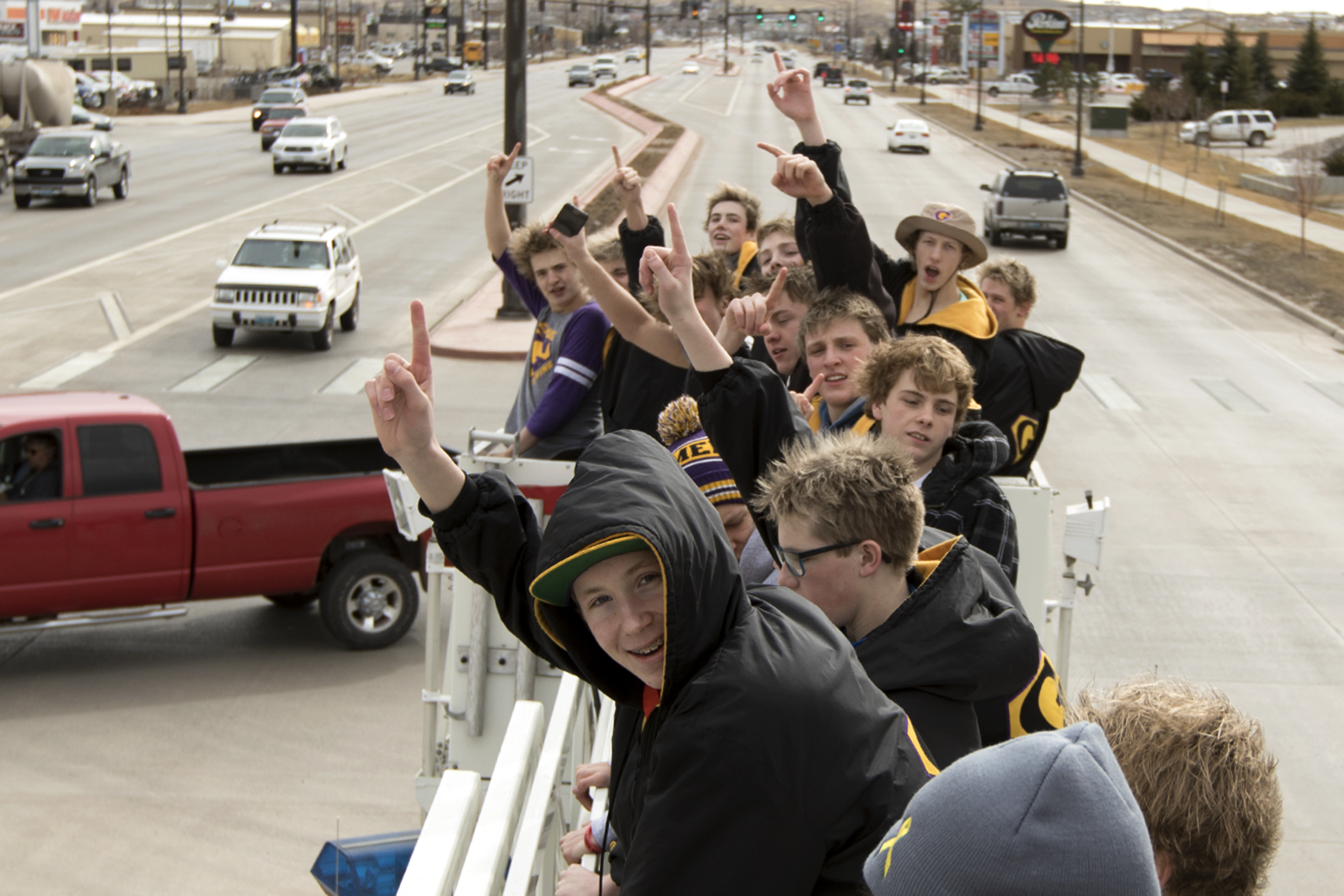 Gillette freshman Gunner Poley, center, and the rest of the Camels swim team celebrate Saturday afternoon on the top of Engine 1 as the Campbell County Fire Department drives the new state champions around town.