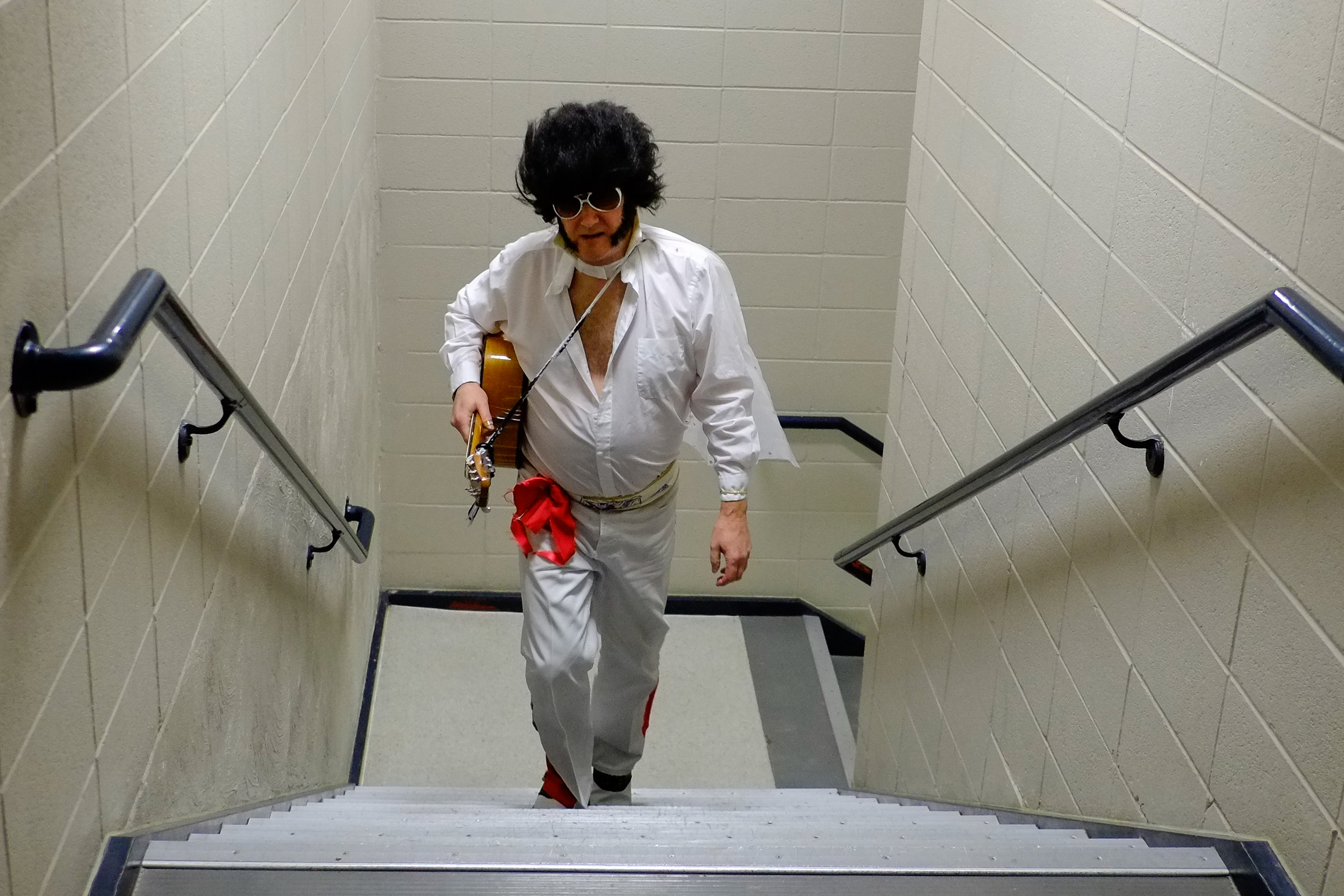 Jim Berman, dressed as Elvis, walks up the stairs at the Heritage Center Theater Saturday evening after playing a song in the Gillette's Got Talent competition.