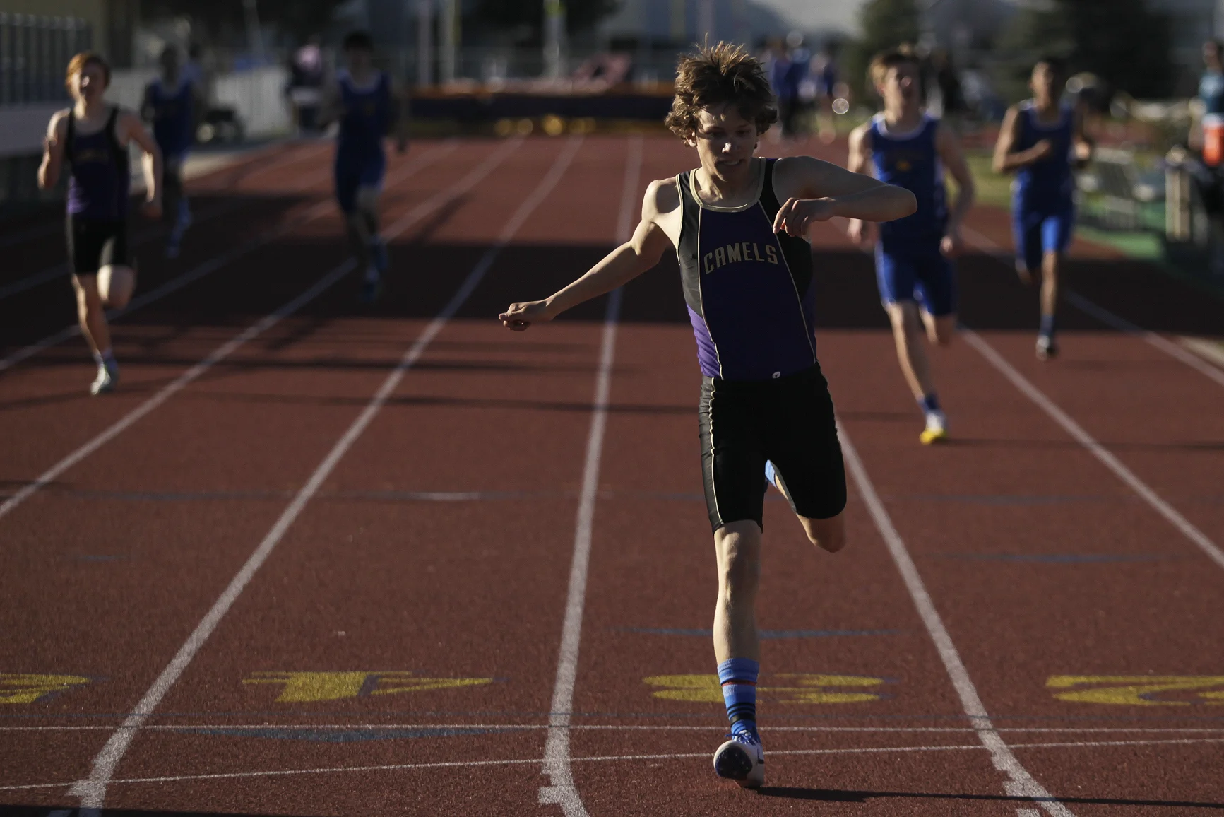 John Bozovich crosses the finish line in the first heat of the boys 400-meter dash Tuesday afternoon during the Camel-Bronc Dual at CCHS North Campus.