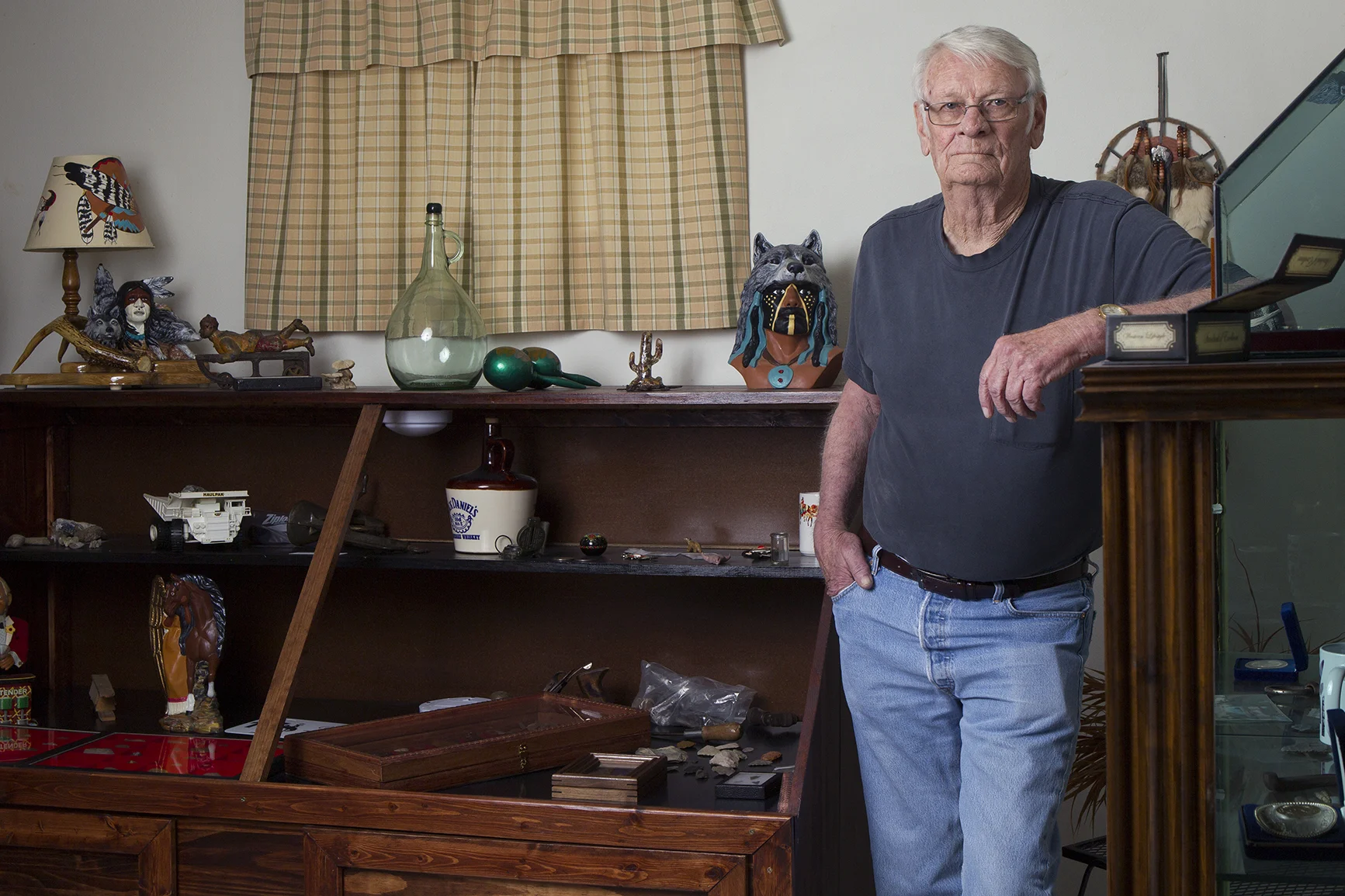 Lifetime Gillette resident Tom Butler stands among his collection of local artifacts at his home on Monday afternoon. Butler, whose family has been in the area since 1916, bought one of the 53 pioneer banners to celebrate the city's 125th anniversary this summer. The banners will hang from the 53 light posts on Gillette Avenue between Twin Spruce and the train track on the north end.