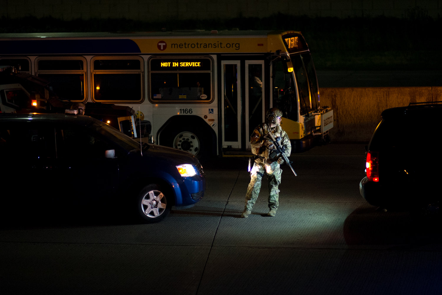 An armed officer stands on Interstate 95 in St. Paul as police break up a protest on the interstate on June 16, 2017. Protesters shut down the interstate after Jeronimo Yanez was found not guilty of second-degree manslaughter for the killing of Philando Castile in July 2016.