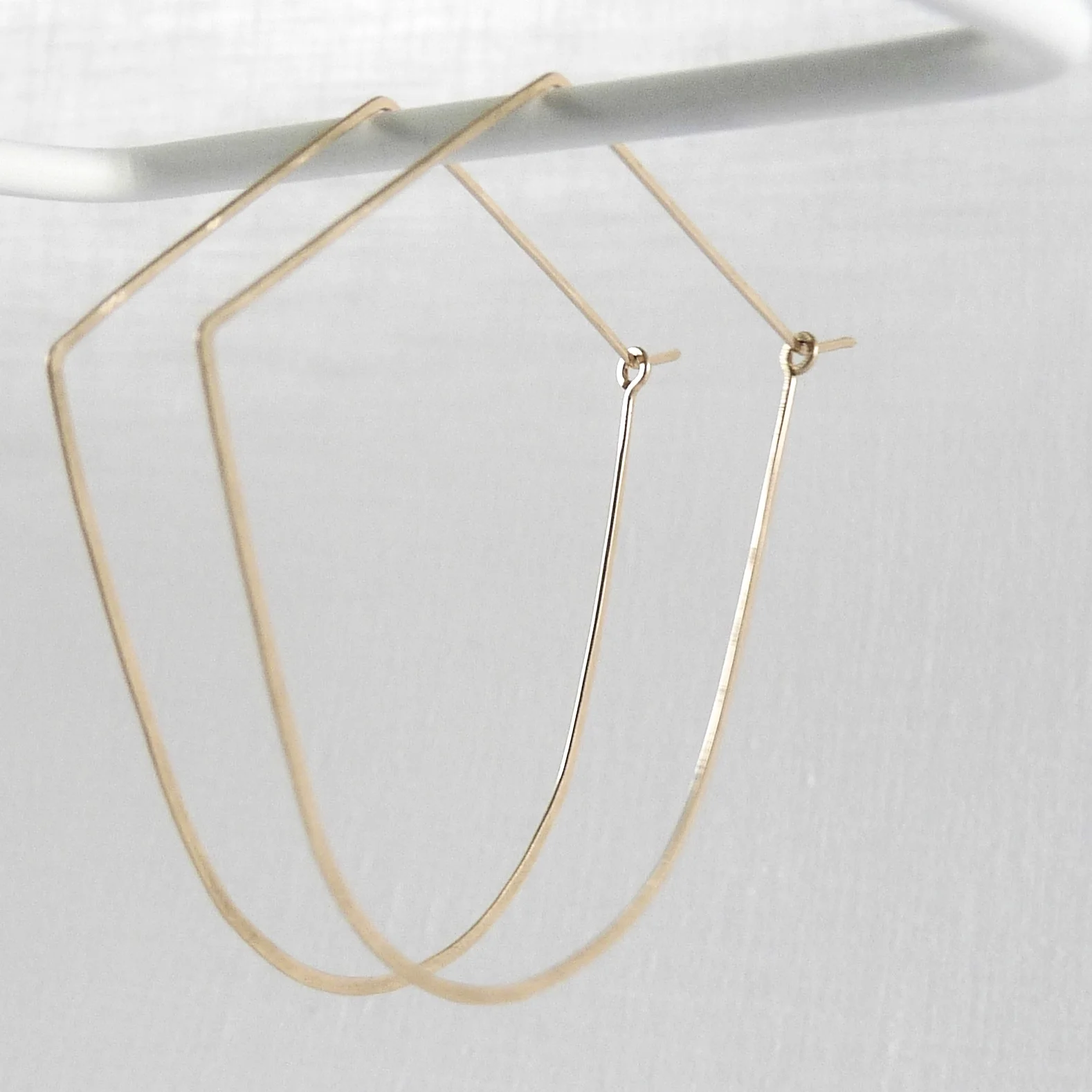 gold arch hoop earrings
