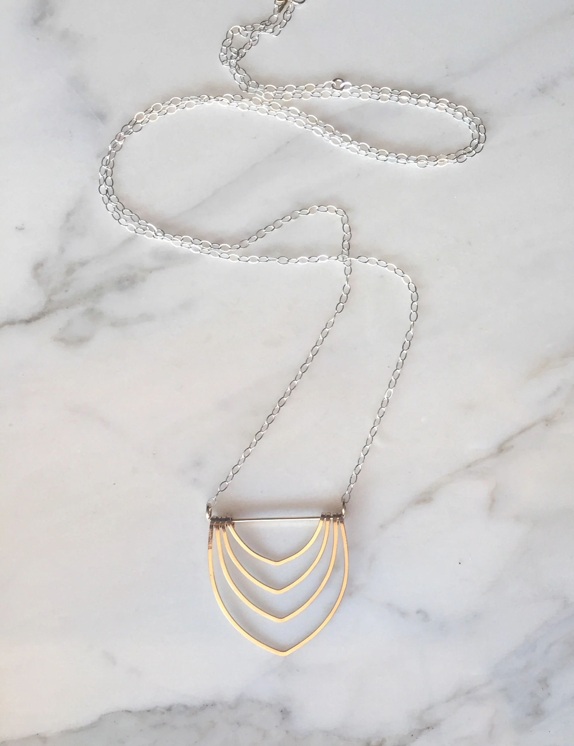 long gold arch necklace